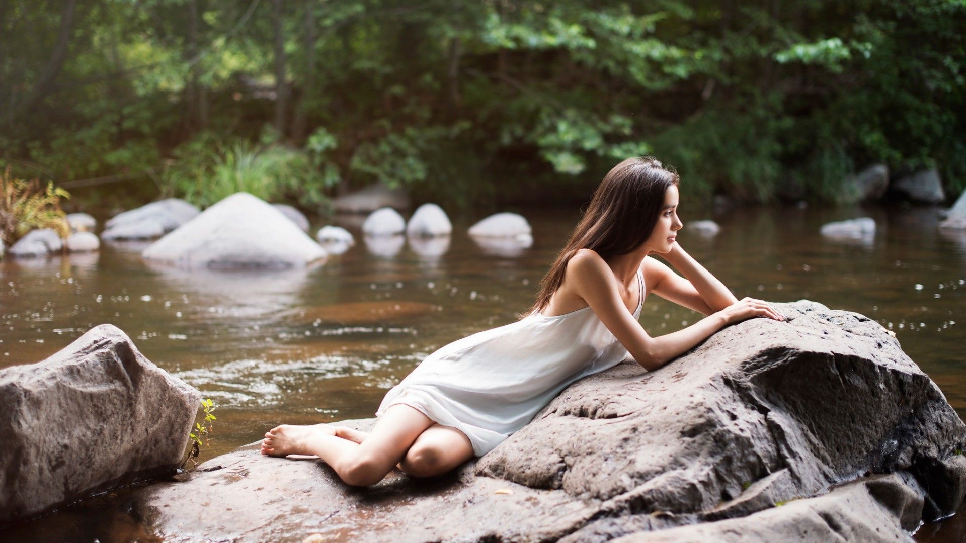 Girl lying on a rock by the river Desktop wallpaper 640x480