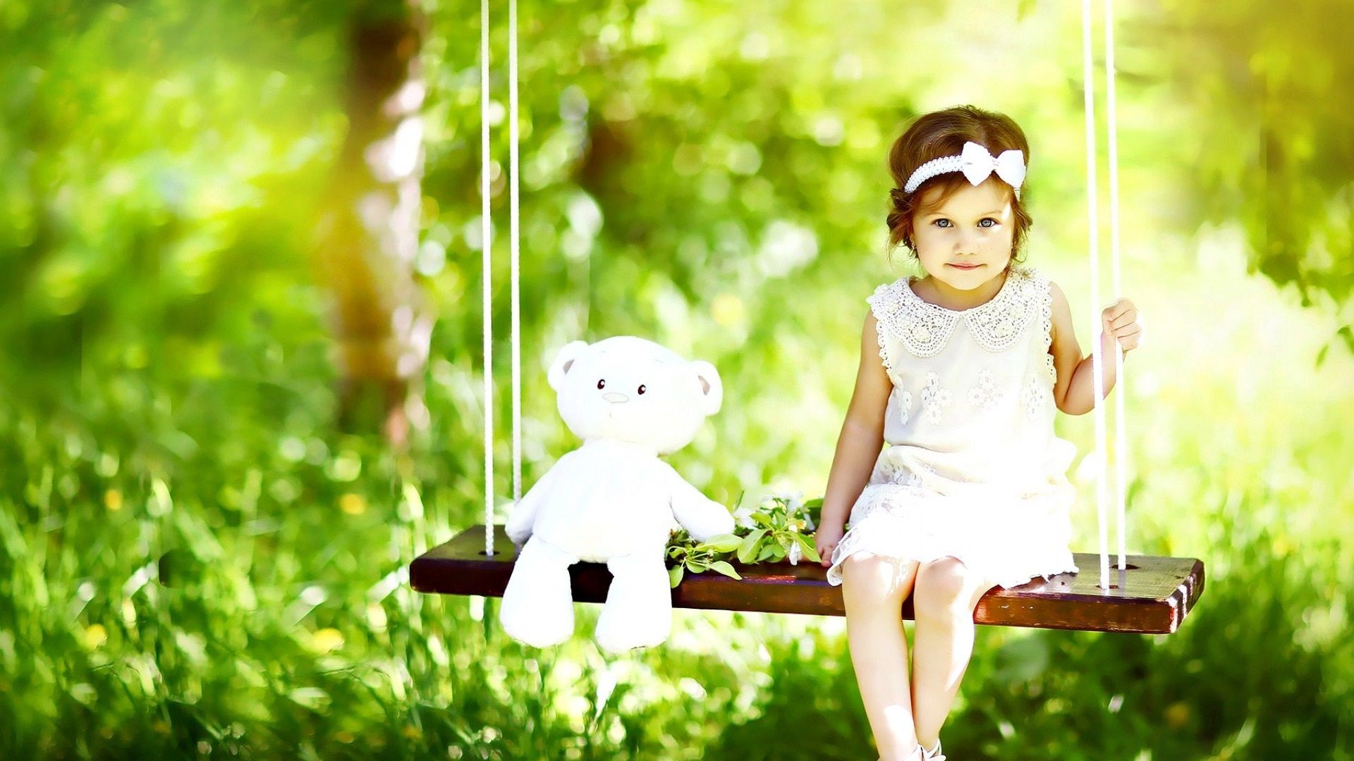 Wallpaper Cute little girl and teddy bear sit on swing 1920x1200