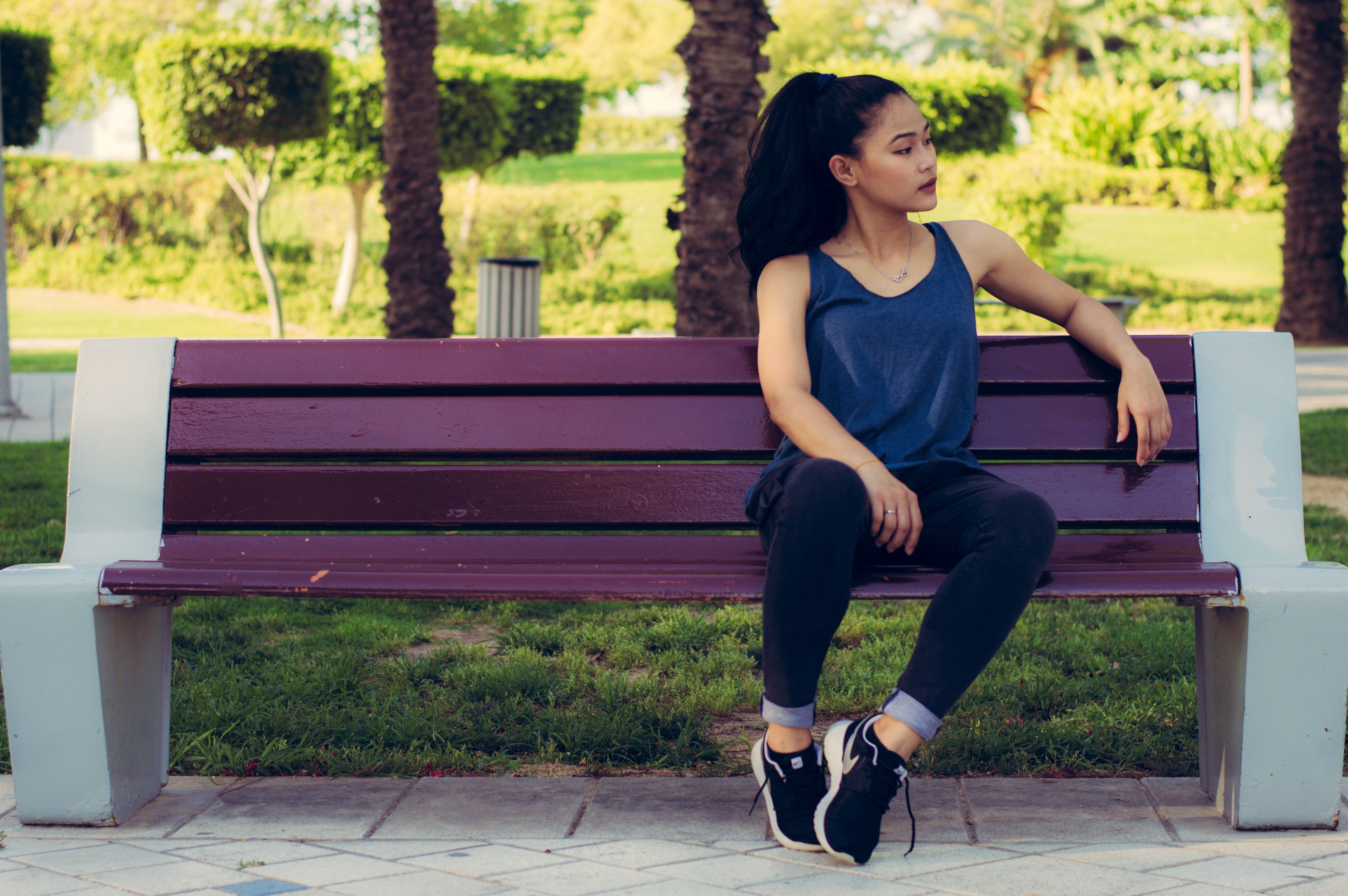 Preggy female sitting upskirt on the city park bench