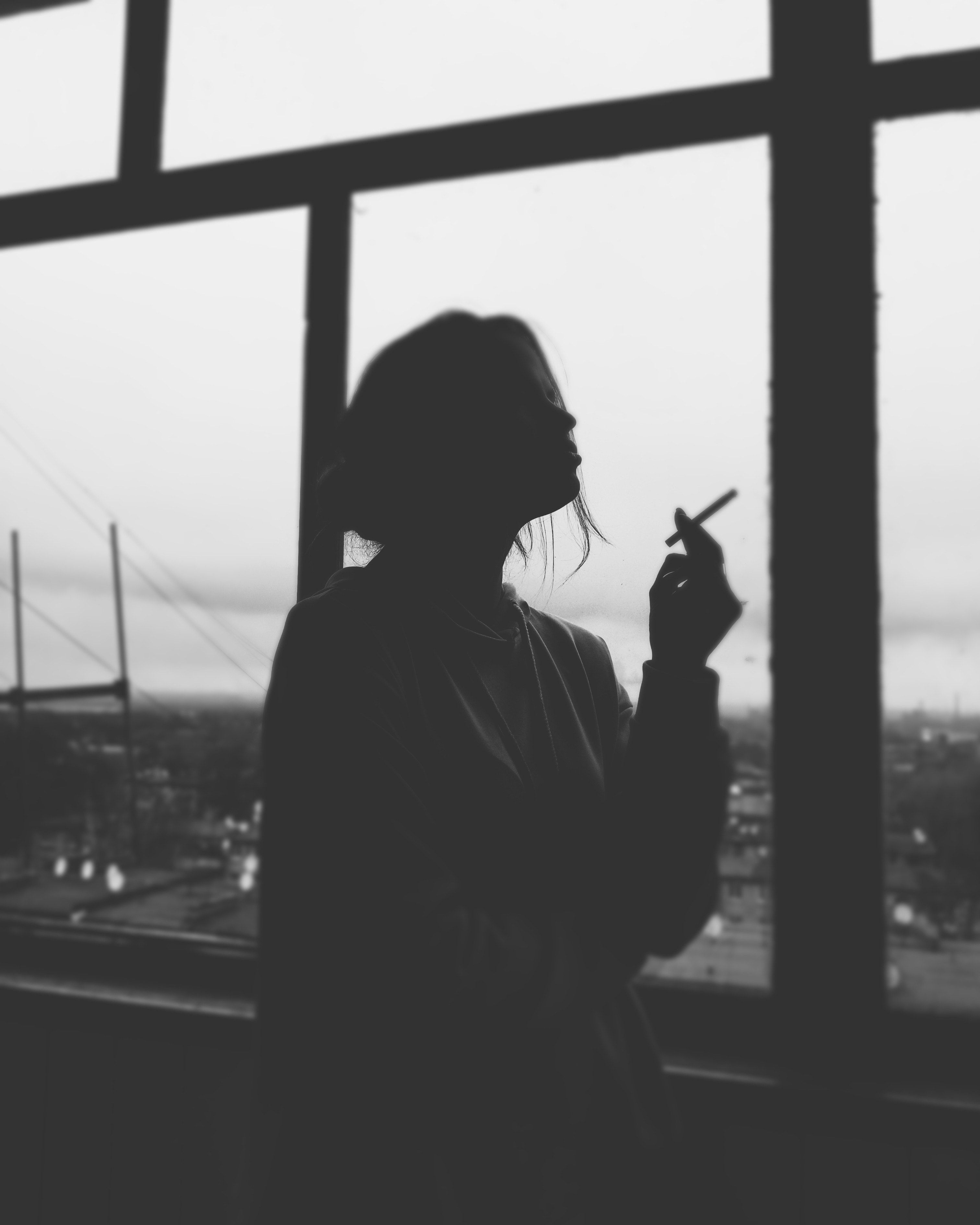 Silhouette Of Woman Smoking Cigarette · Free