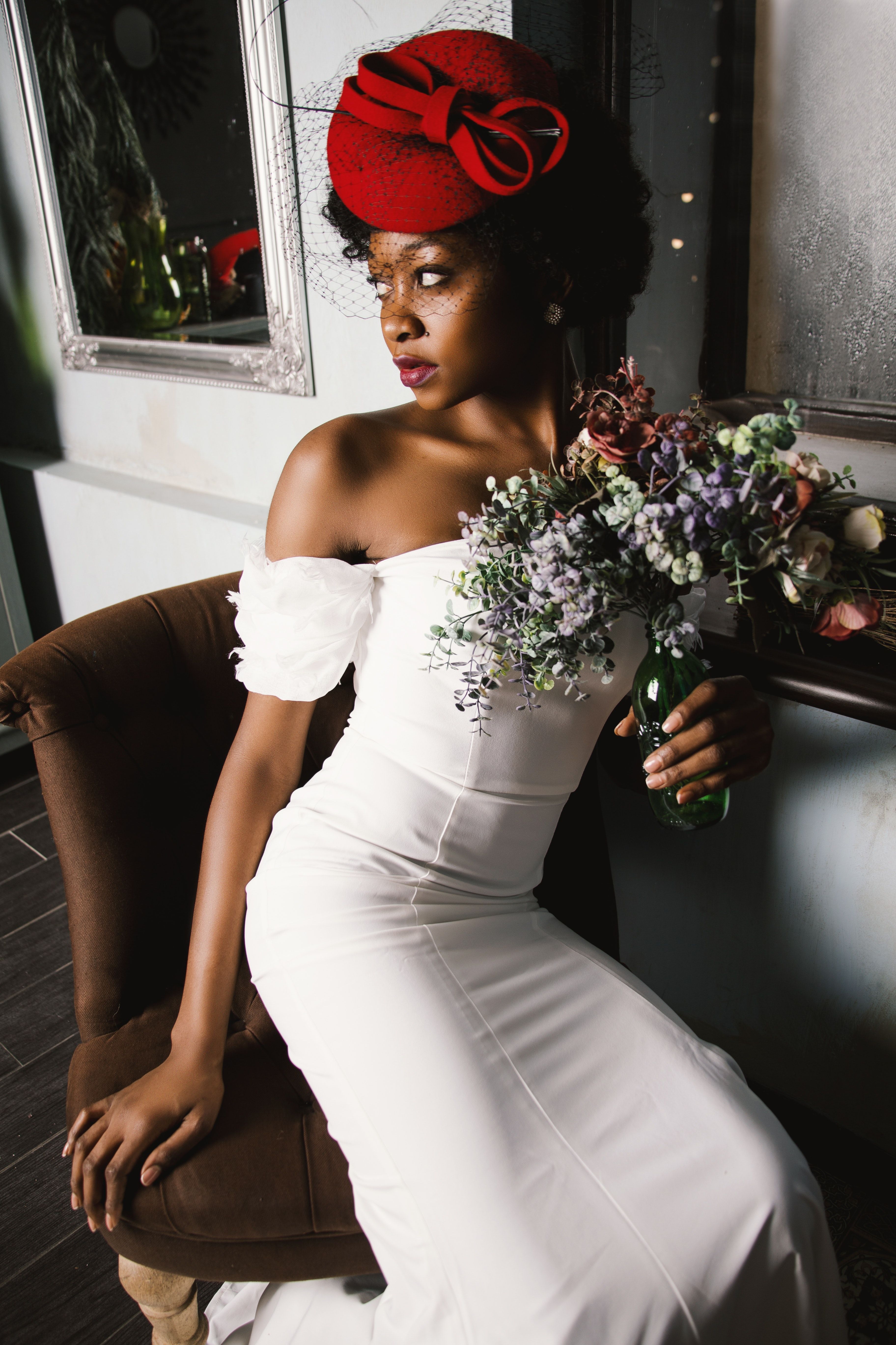 Woman Wearing White Off Shoulder Bodycon Dress Holding Flower