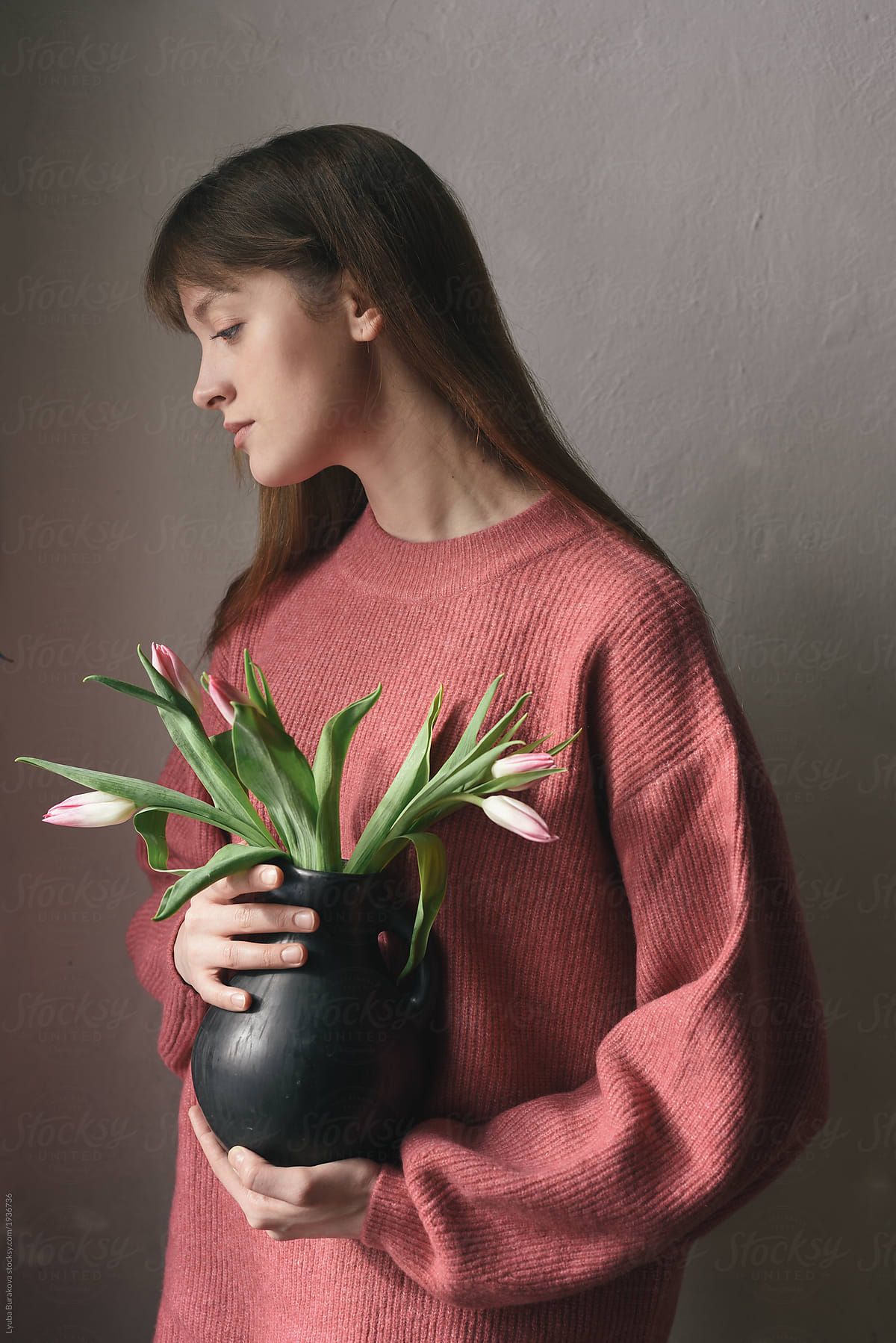 Woman holding vase with tulips by Lyuba Burakova, Tulip