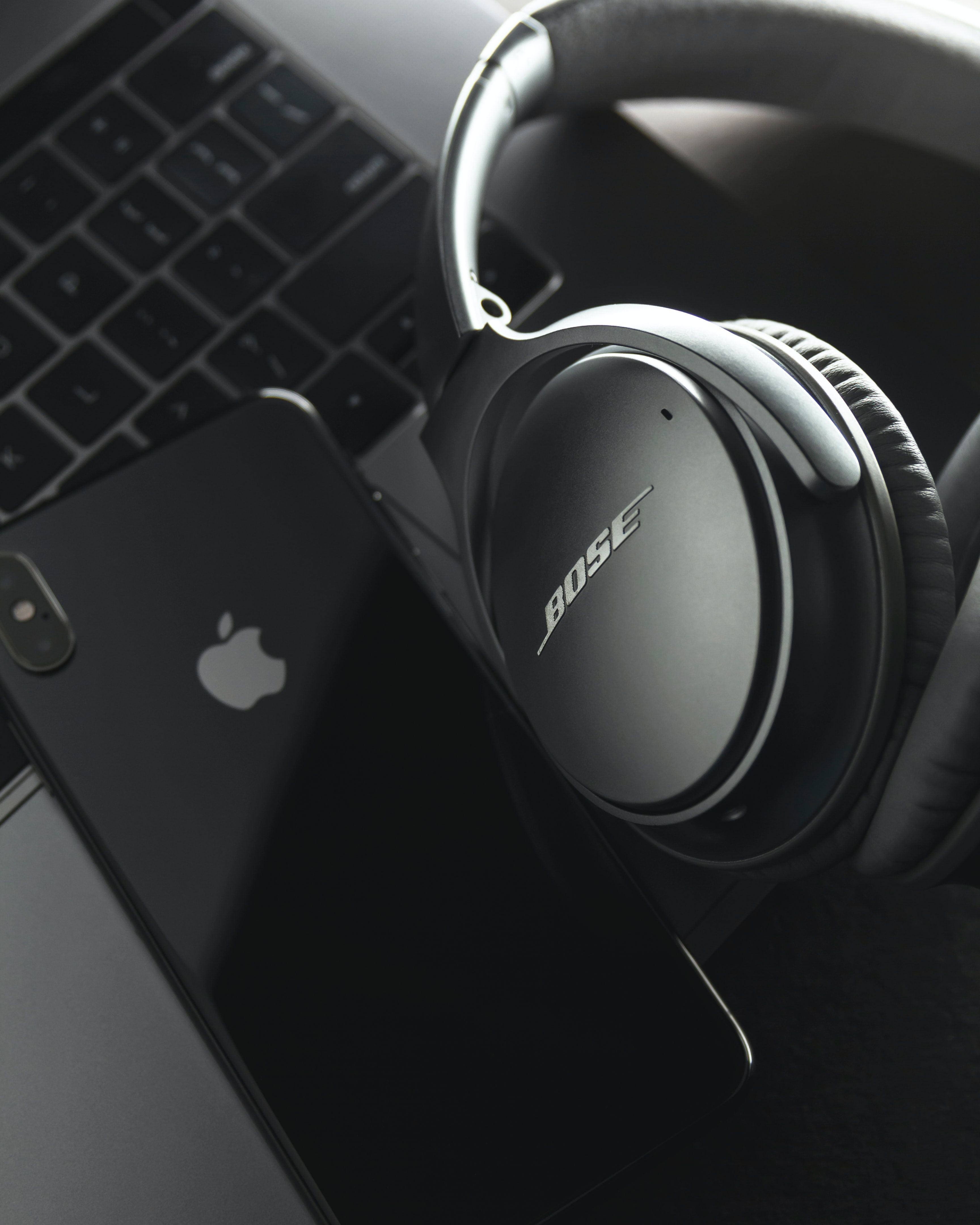 gray and black Bose headset and black iPhone X photo