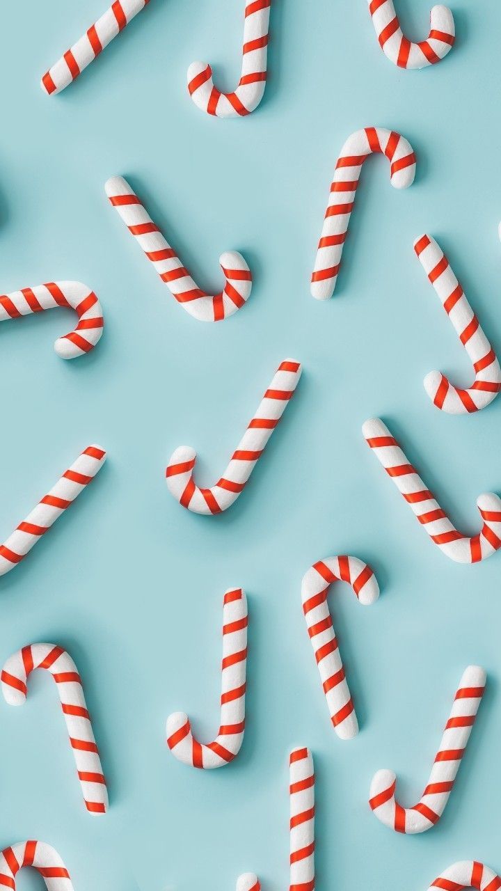Premium Vector  Seamless christmas background with cute candy cane vector  illustration in flat cartoon style on a pink background ideal for fabric  and wrapping paper
