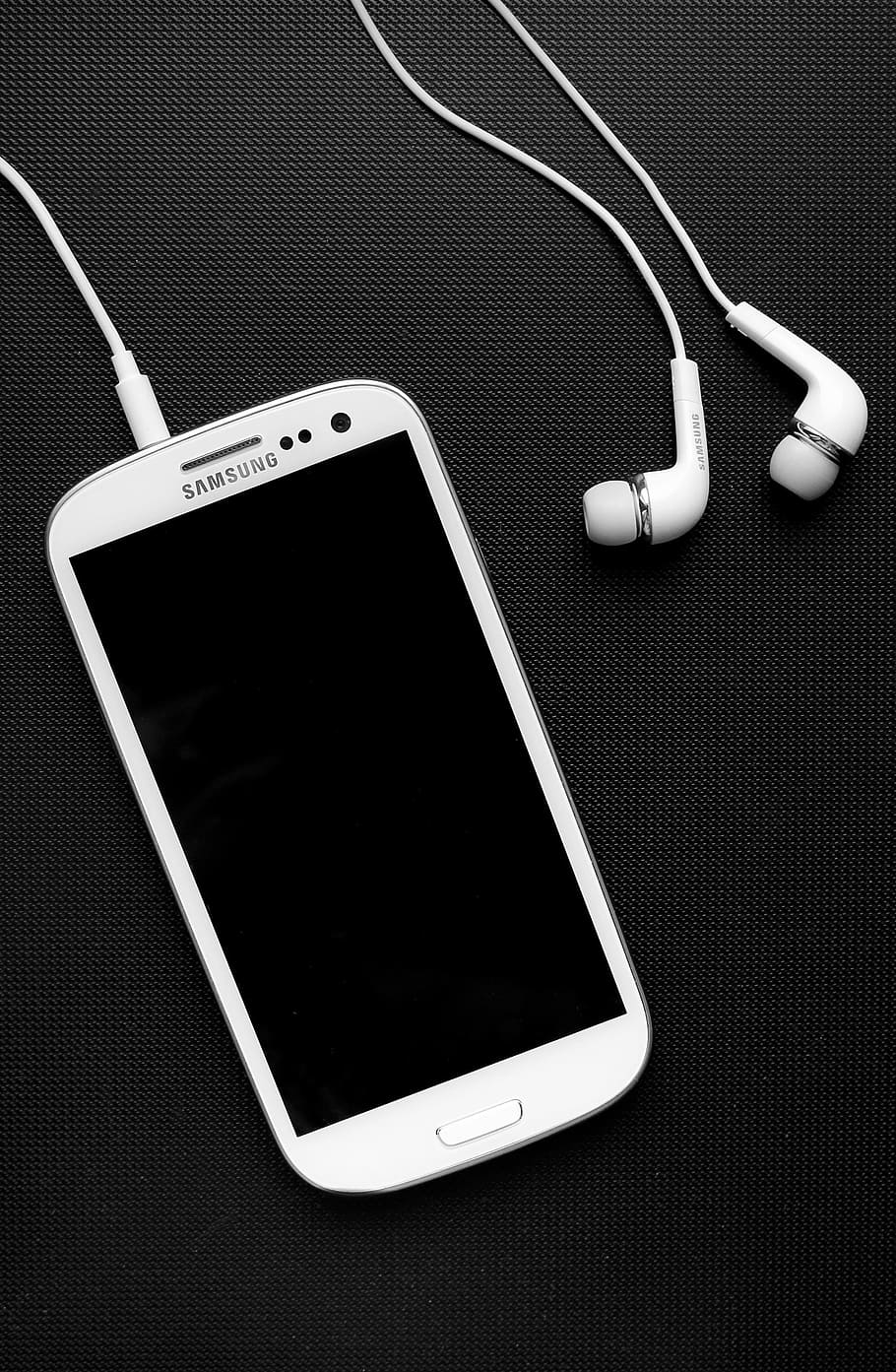 HD wallpaper: white Samsung Galaxy smartphone beside earphones