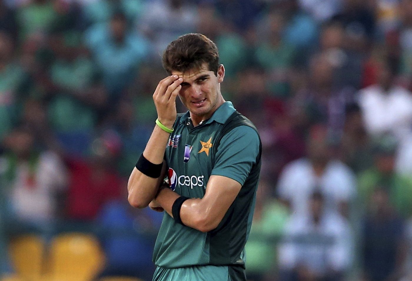 Shaheen Afridi reacts after a shot is played off his bowling