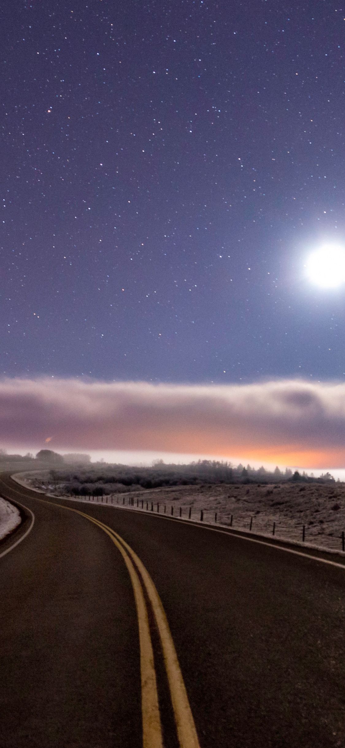 Download 1125x2436 wallpaper highway, sky, clouds, landscape