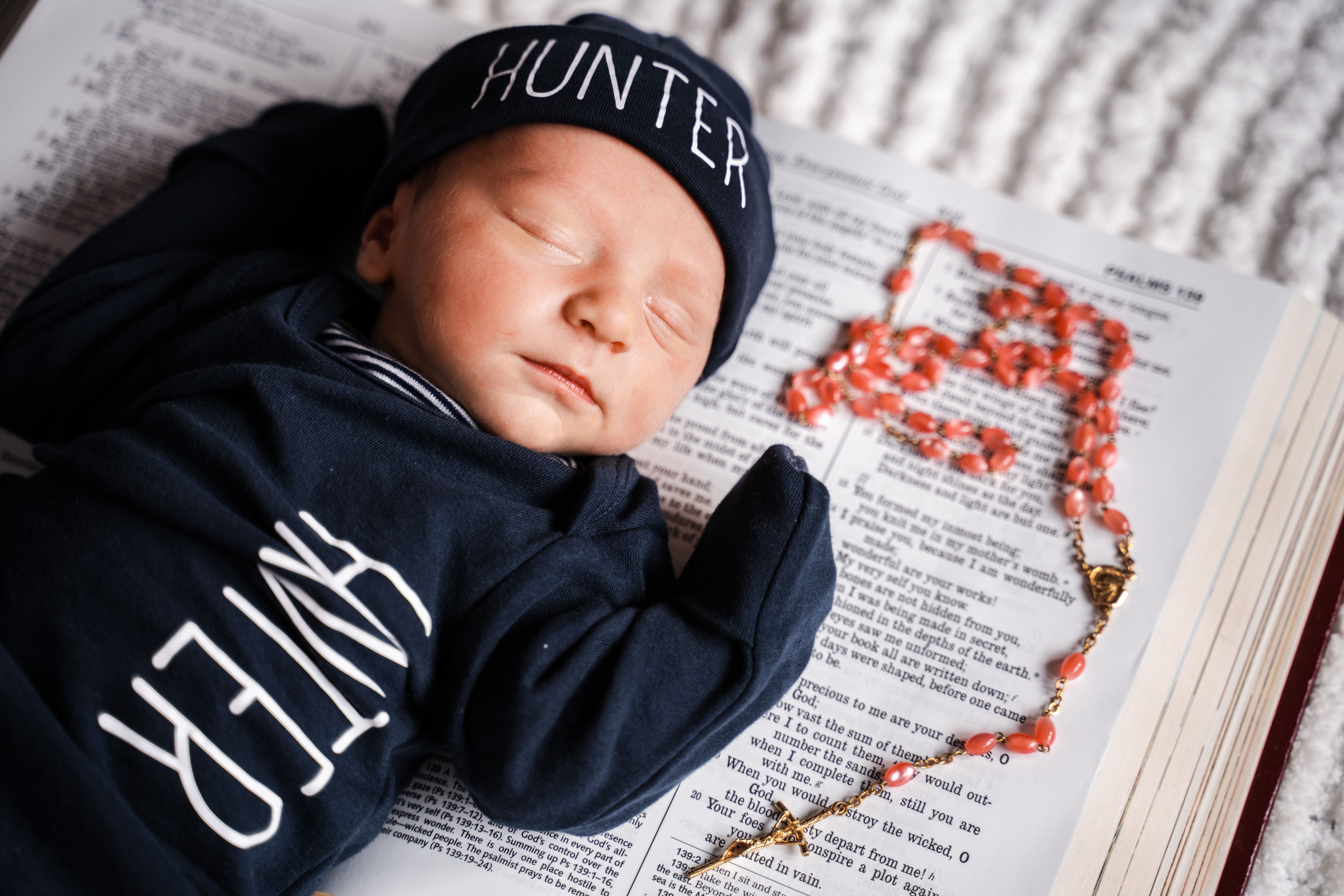 Baby Lying on Bible Near the Rosary · Free