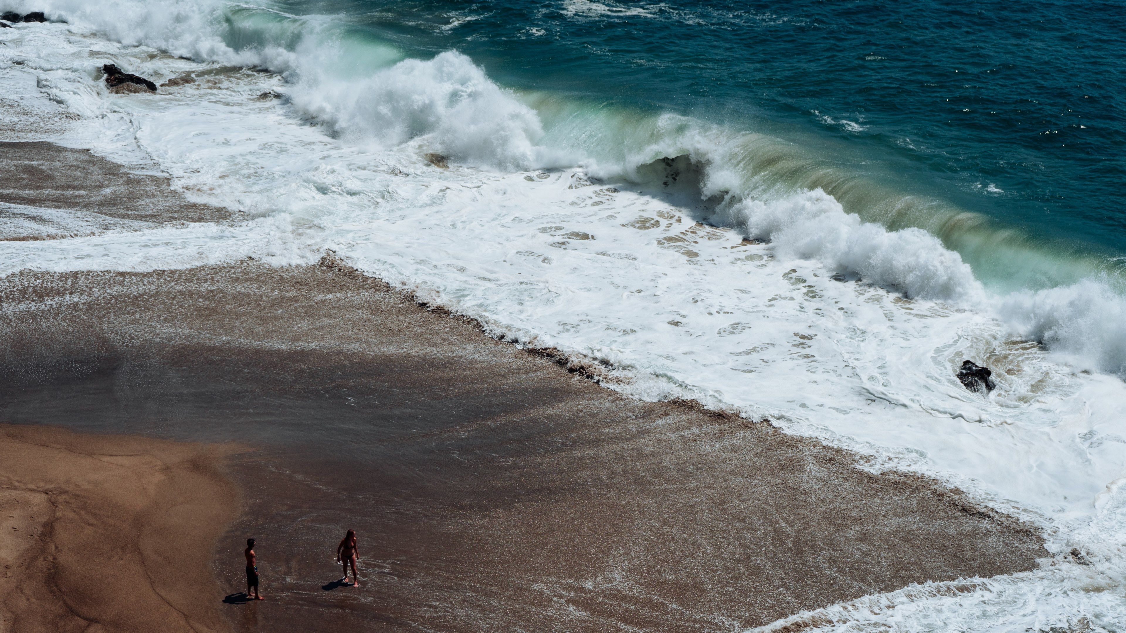 waves crashing on the sand beach at point dume state beachheading