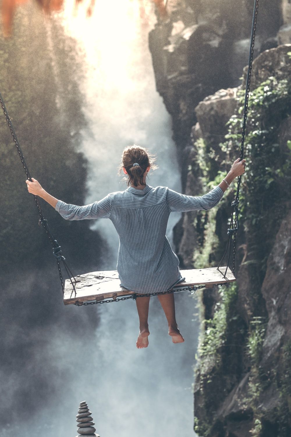 woman riding on wooden swing photo
