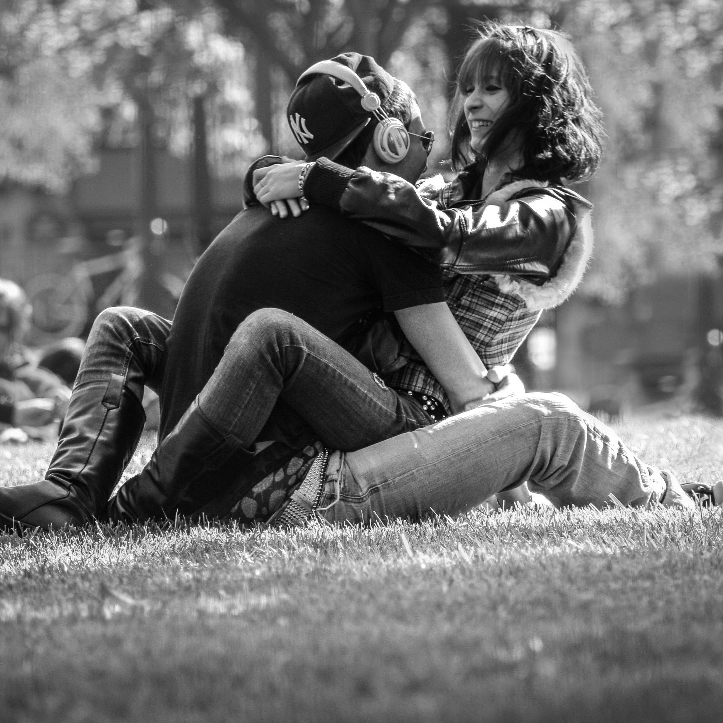 Grayscale Photo of Man and Woman Hugging on Grass · Free