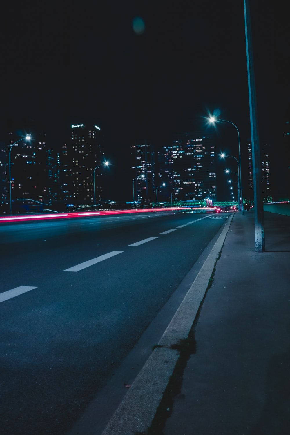 empty street with lights during nighttime photo