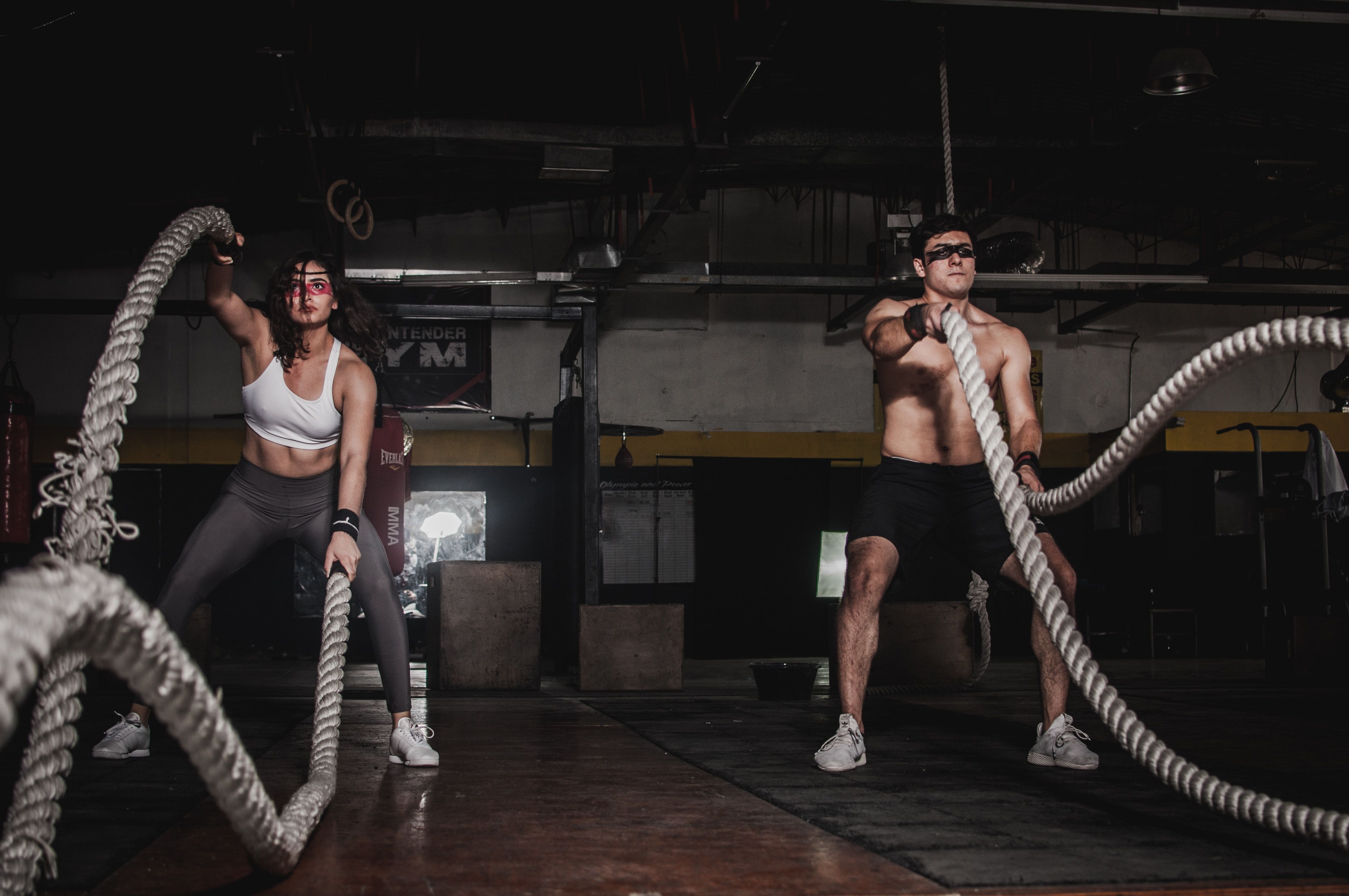 Man And Woman Holding Battle Ropes · Free
