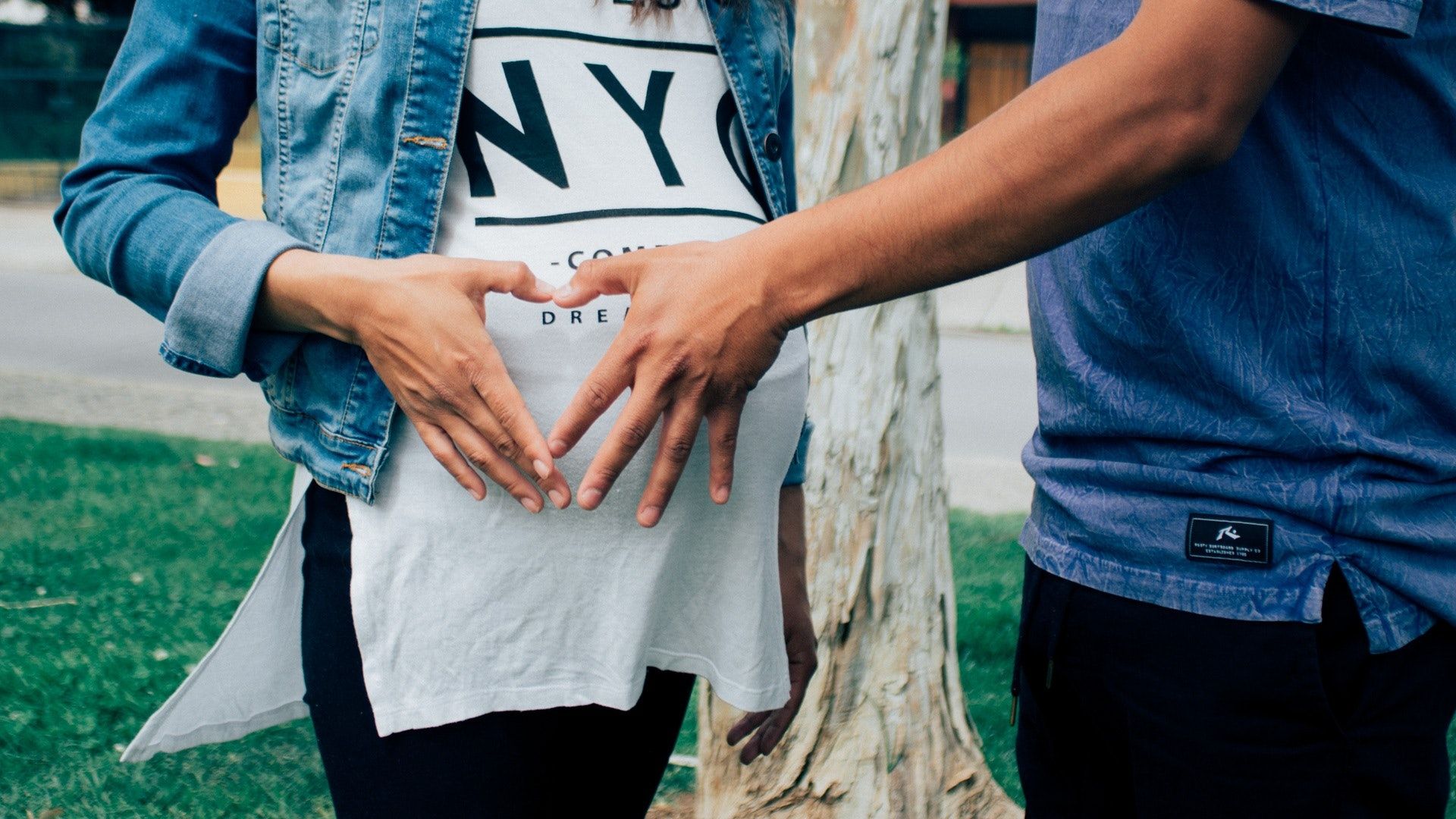 Pregnant Woman Holding Her Tummy Together With a Man Beside · Free