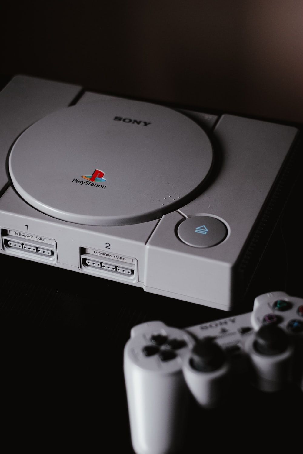 photo of closed Sony PS1 with DualShock 1 photo