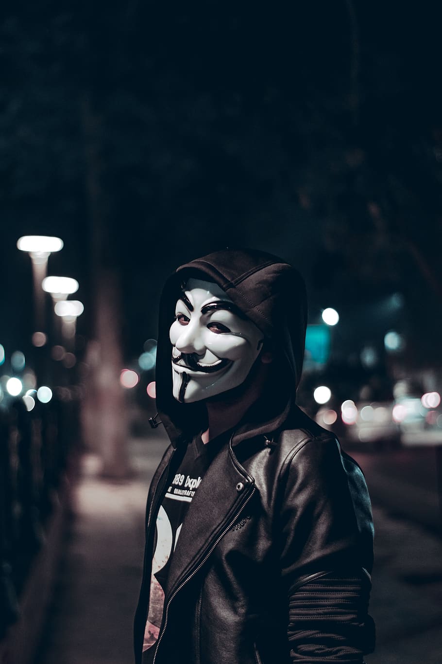 HD wallpaper: Person Wearing Guy Fawkes Mask, black leather jacket, blur, city lights