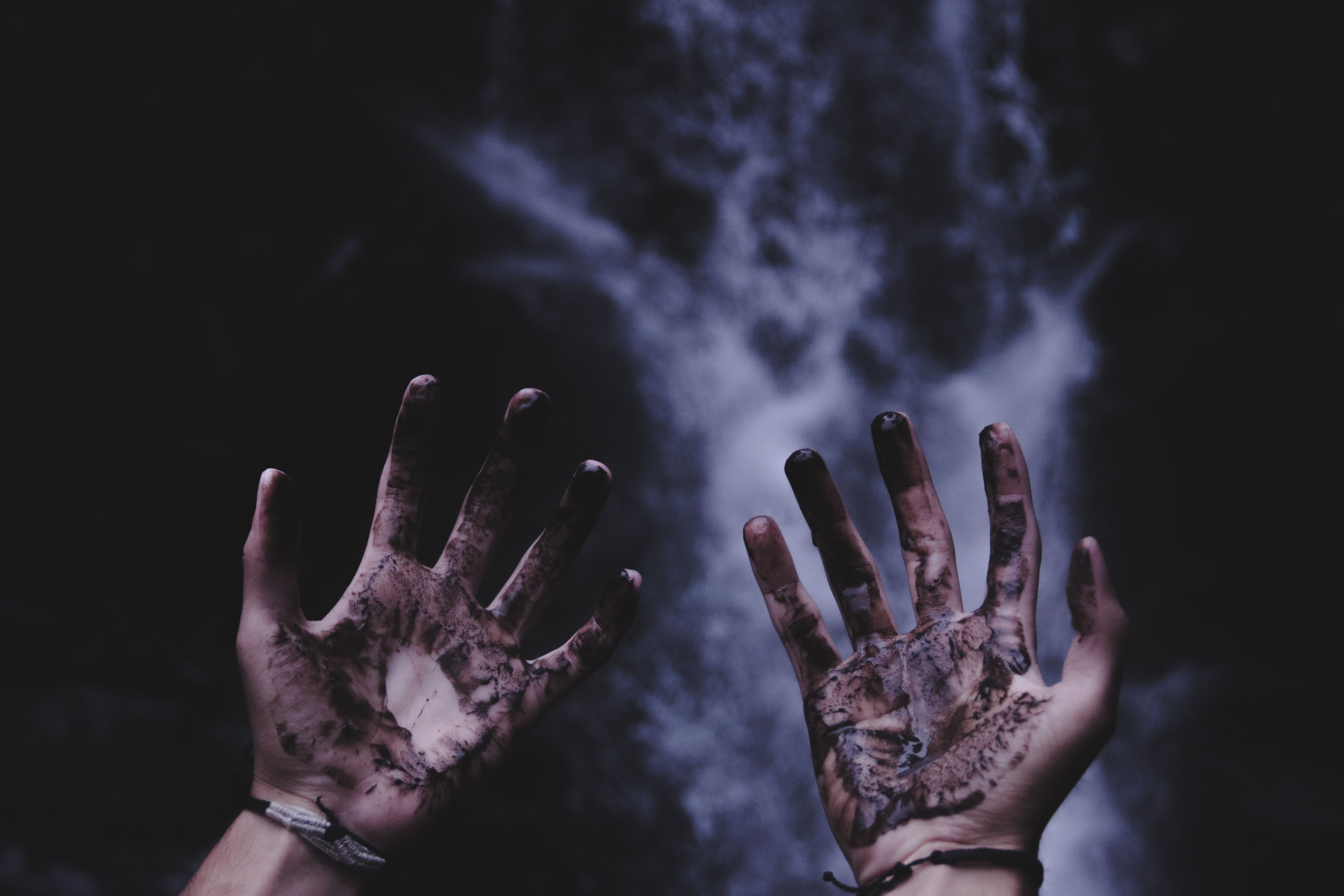 person hands with black liquids photo