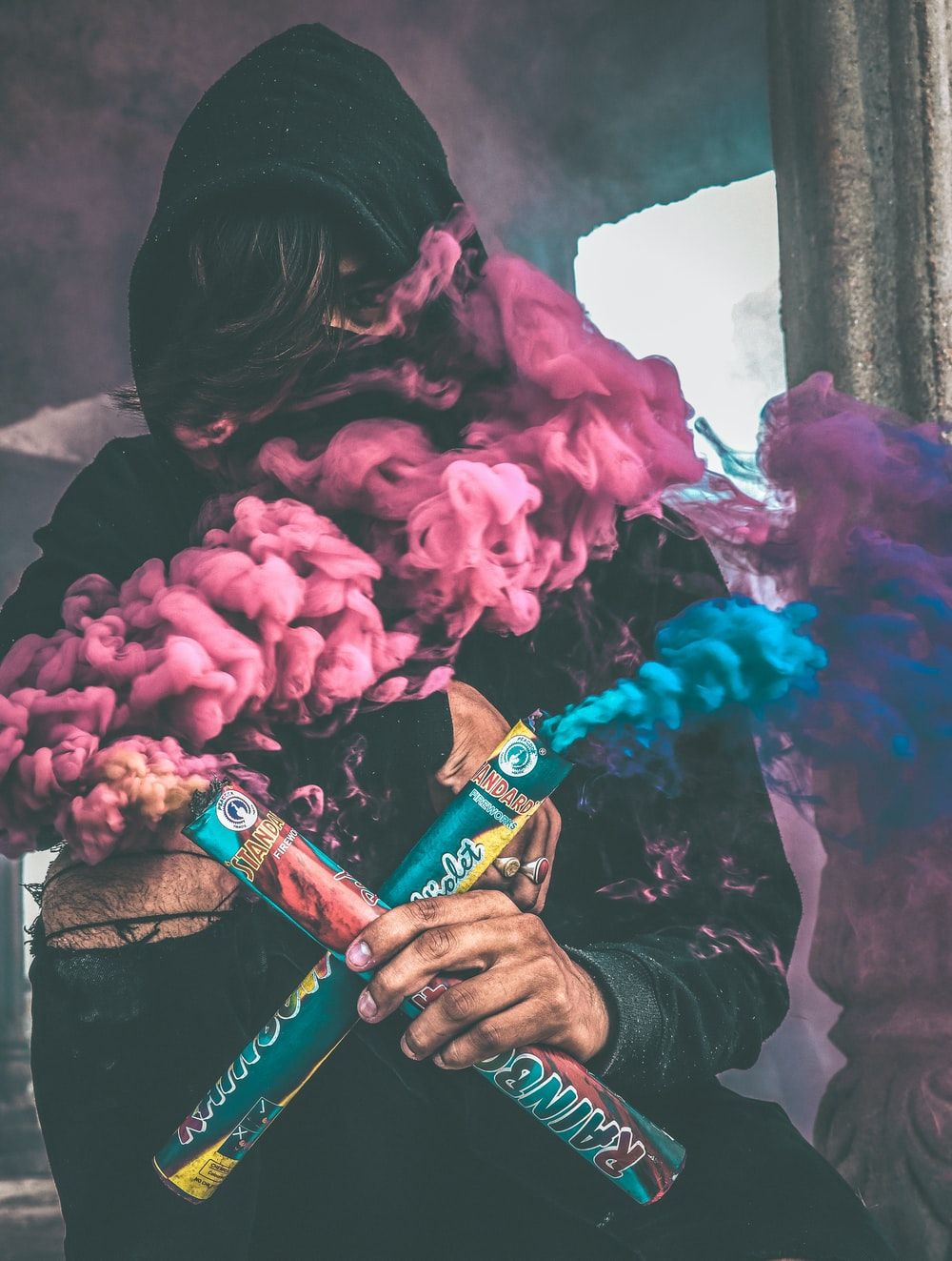 person holding colored smoke photo
