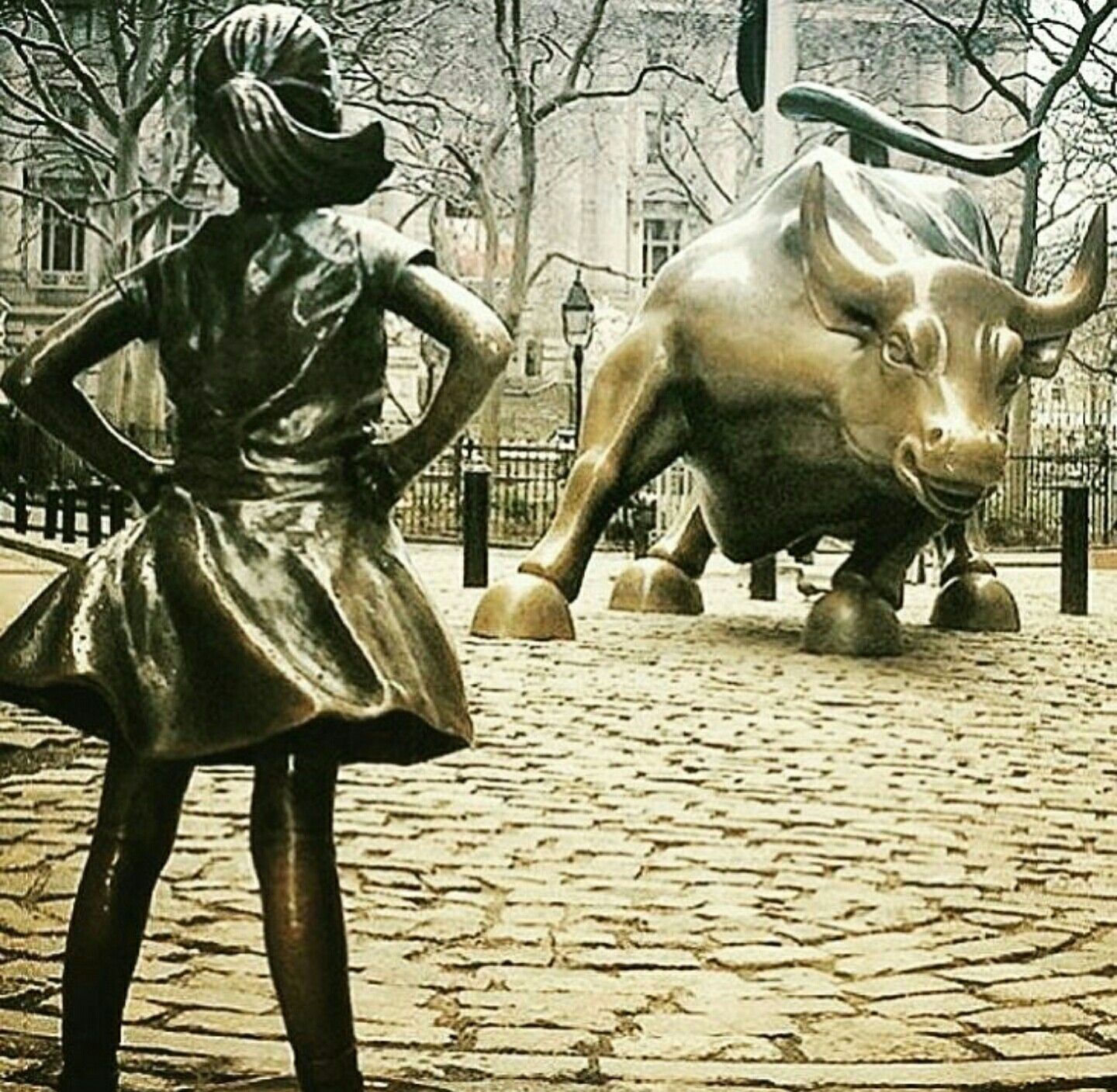 Fearless girl statue wall Street charging bull empowered strong