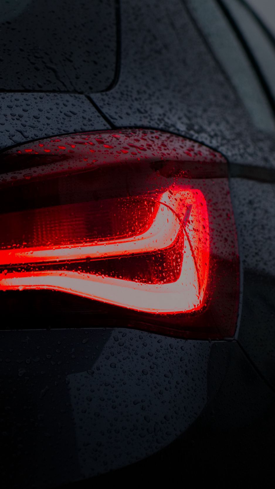 Download wallpaper 938x1668 car, black, wet, taillight, backlight