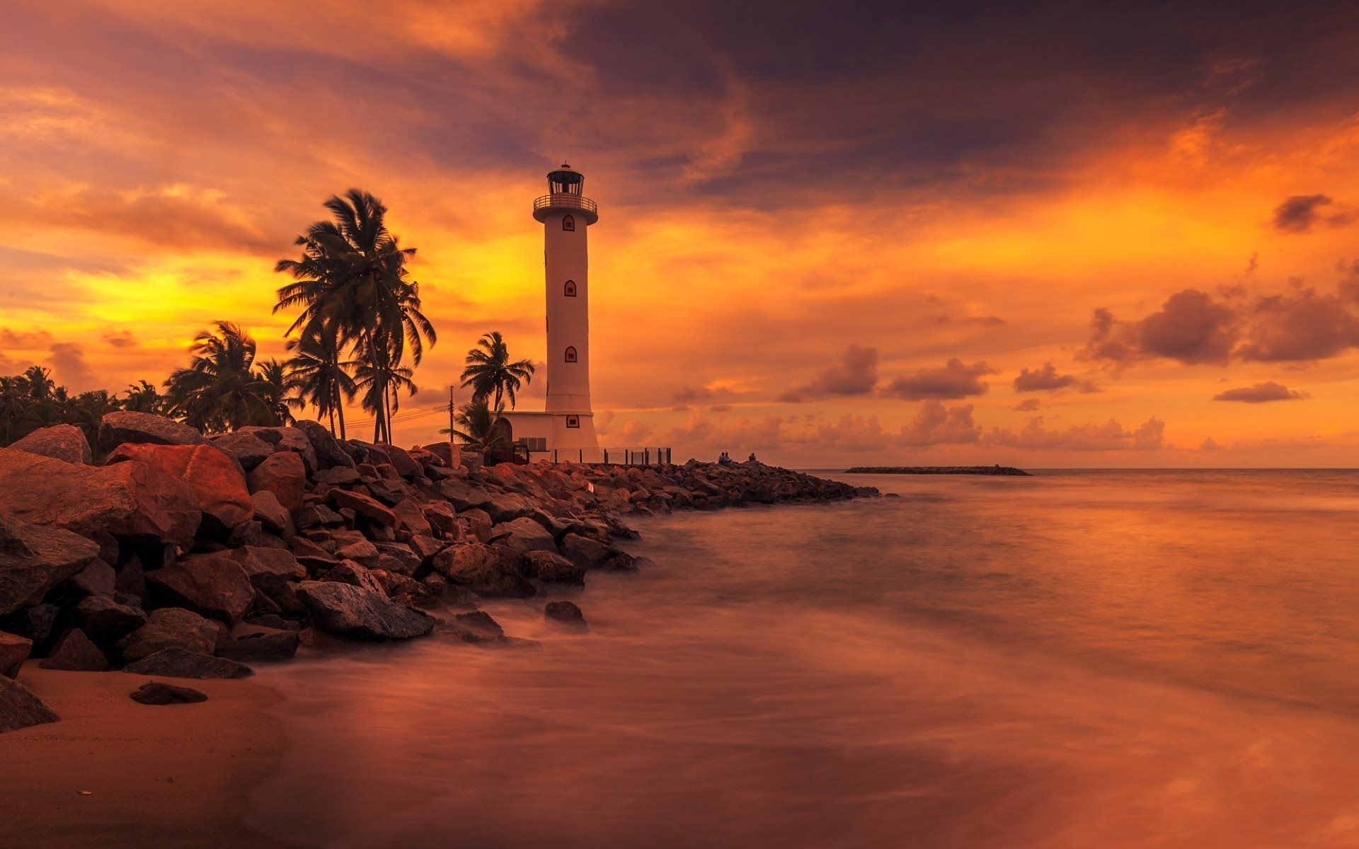 Download wallpaper Lighthouse, palm trees, sunset, evening, beach