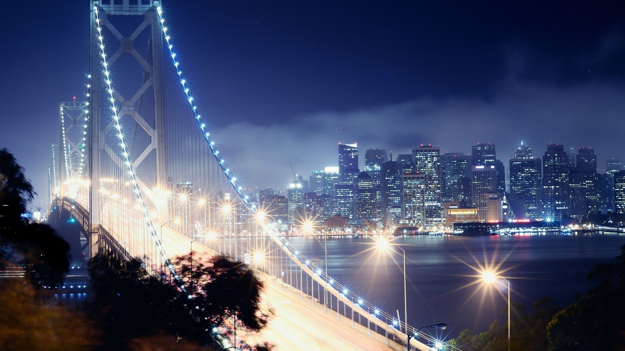Download 2560x1440 Bridge, Lights, Cityscape, Night, Buildings