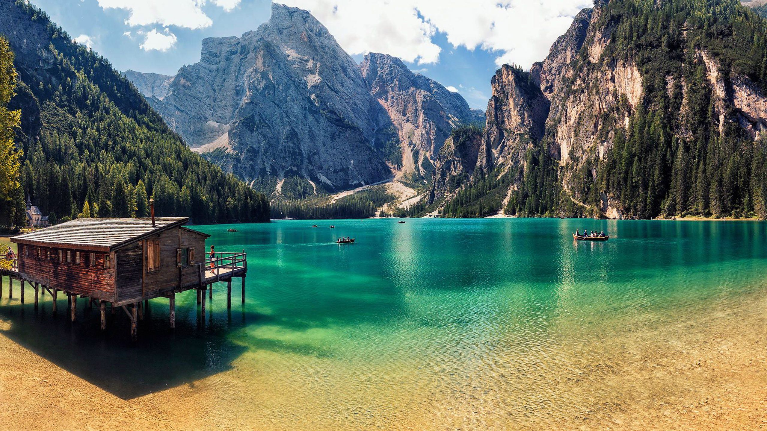 Pragser Wildsee Italy Blue Mountain Lake Clear Water Wooden House On Pillars Rocky Mountains Pine Forest Boating With Boat Summer Wallpaper HD 2560x1440, Wallpaper13.com