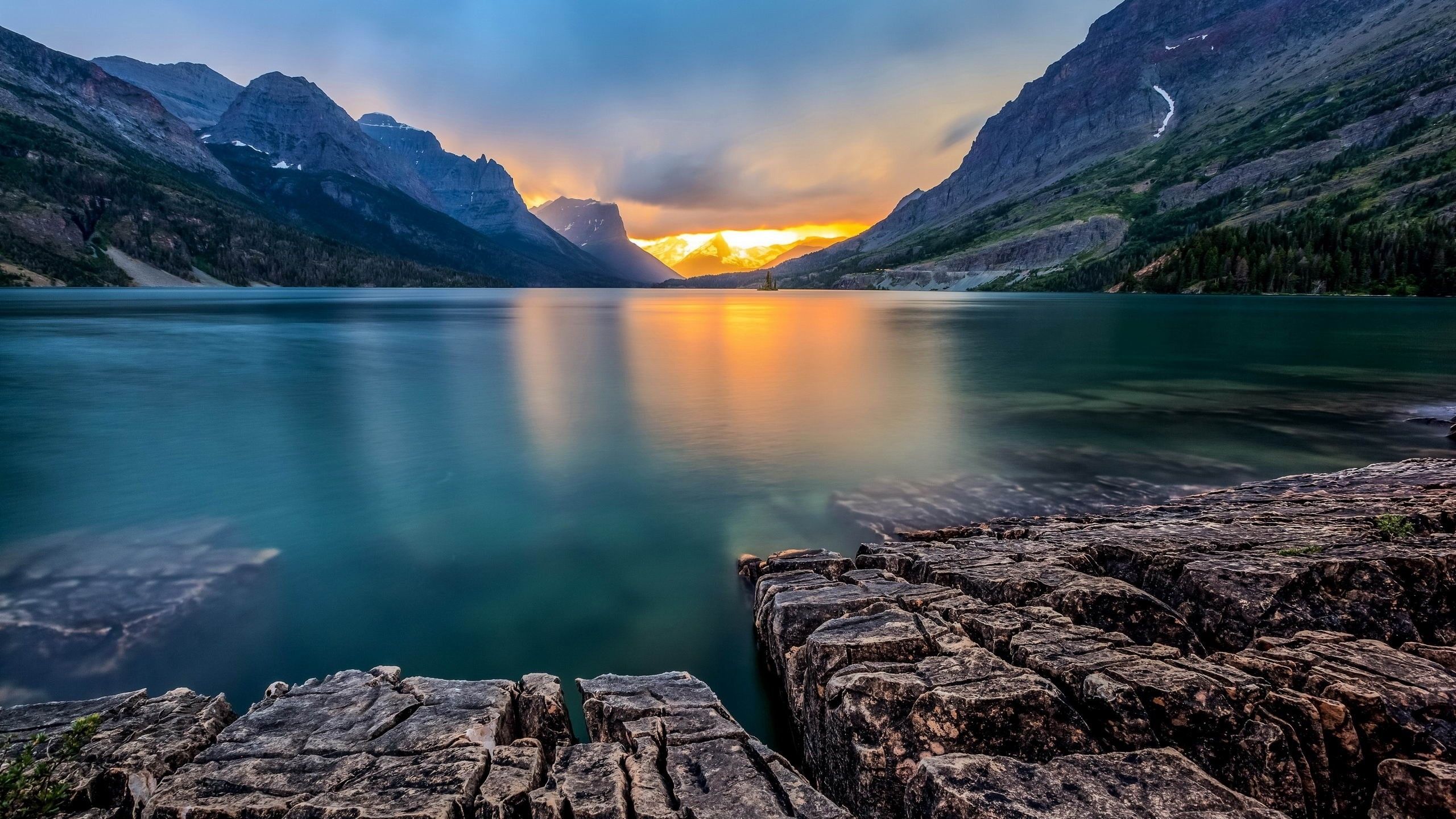 Download 2560x1440 Mountain, Sunset, Lake, Rocks, Sky, Clouds