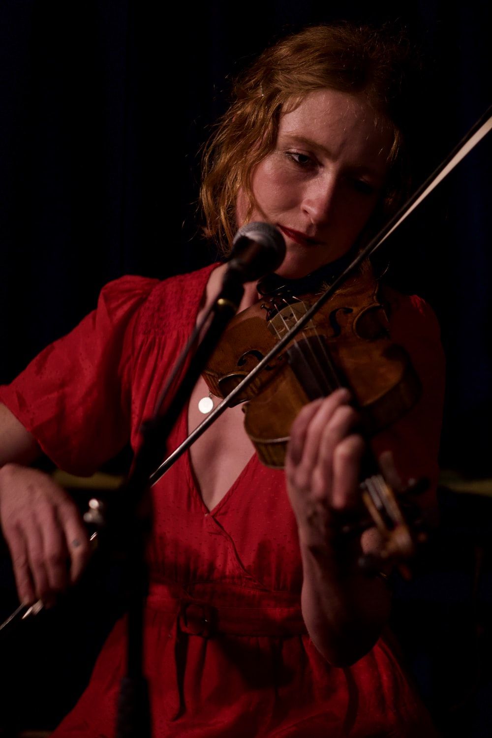 woman playing violin in front of microphone photo