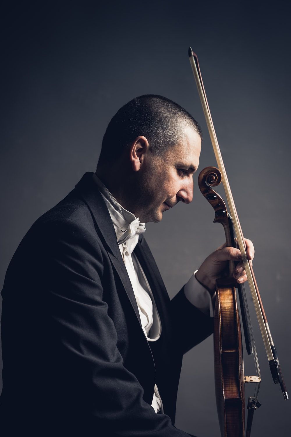 man holding violin and bow photo