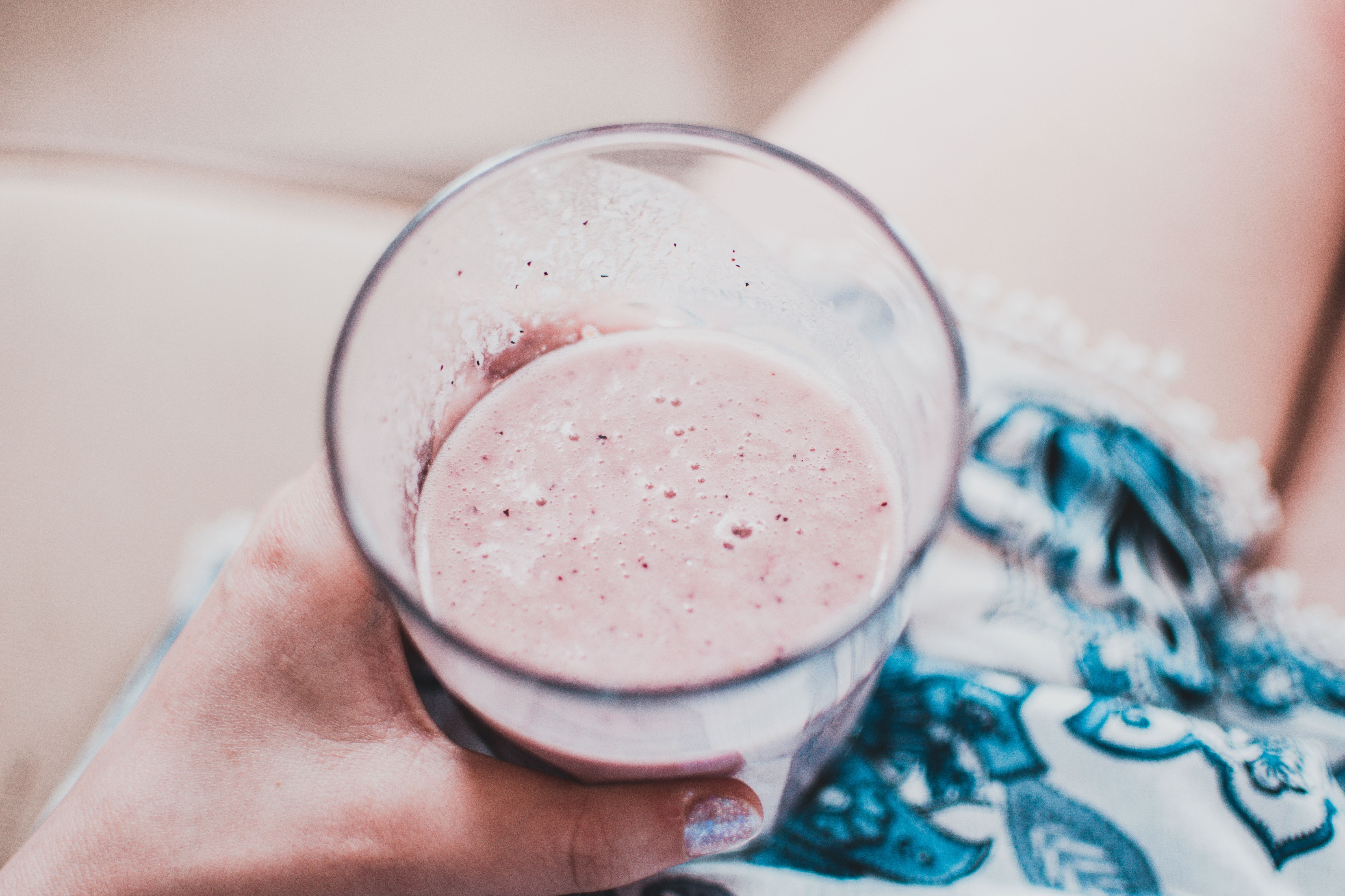 Person Holding Clear Drinking Glass With Fruit Shake Close Up Photo Wallpaper