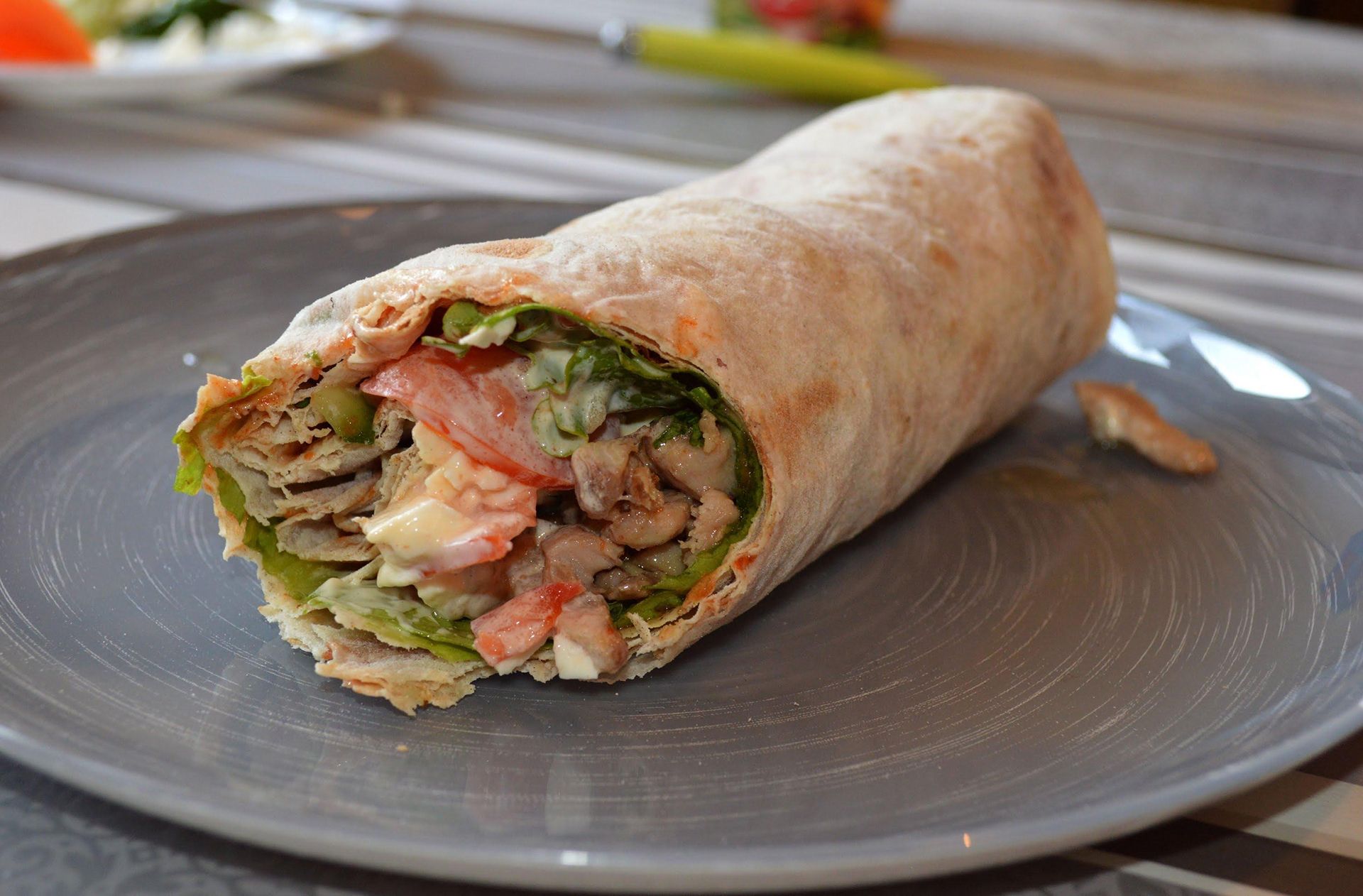 Delicious shawarma served on wooden board on table in cafe. Grilled pita  wrapping chicken meat and fresh vegetables with sauce. healthy food.  Generetive Ai 30387671 Stock Photo at Vecteezy