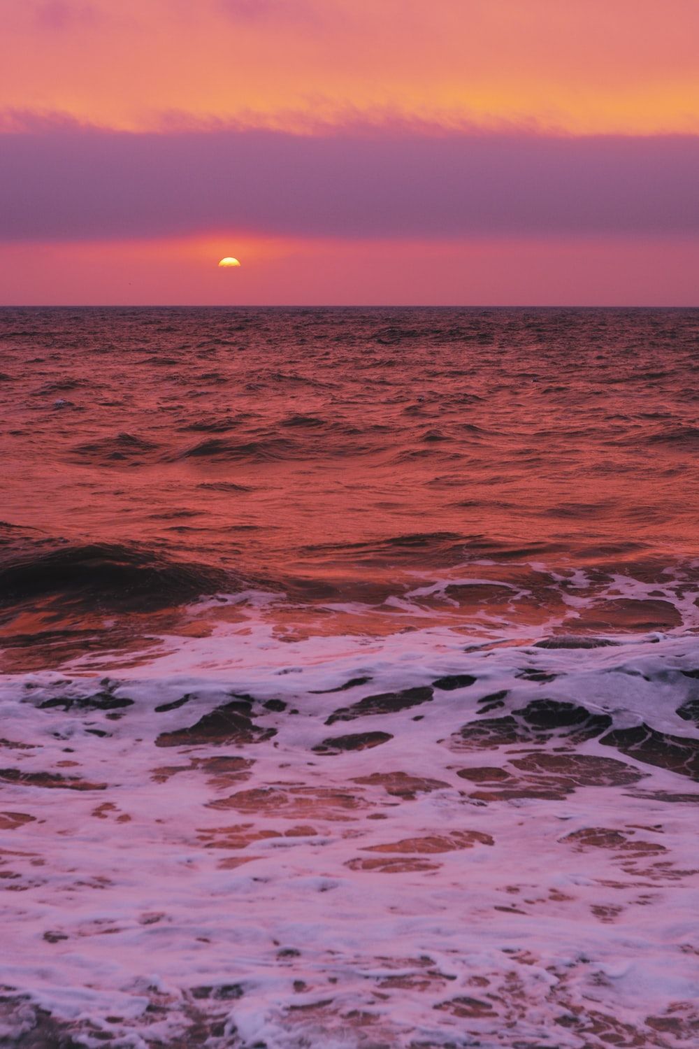 time lapse photography of ocean waves during sunset photo