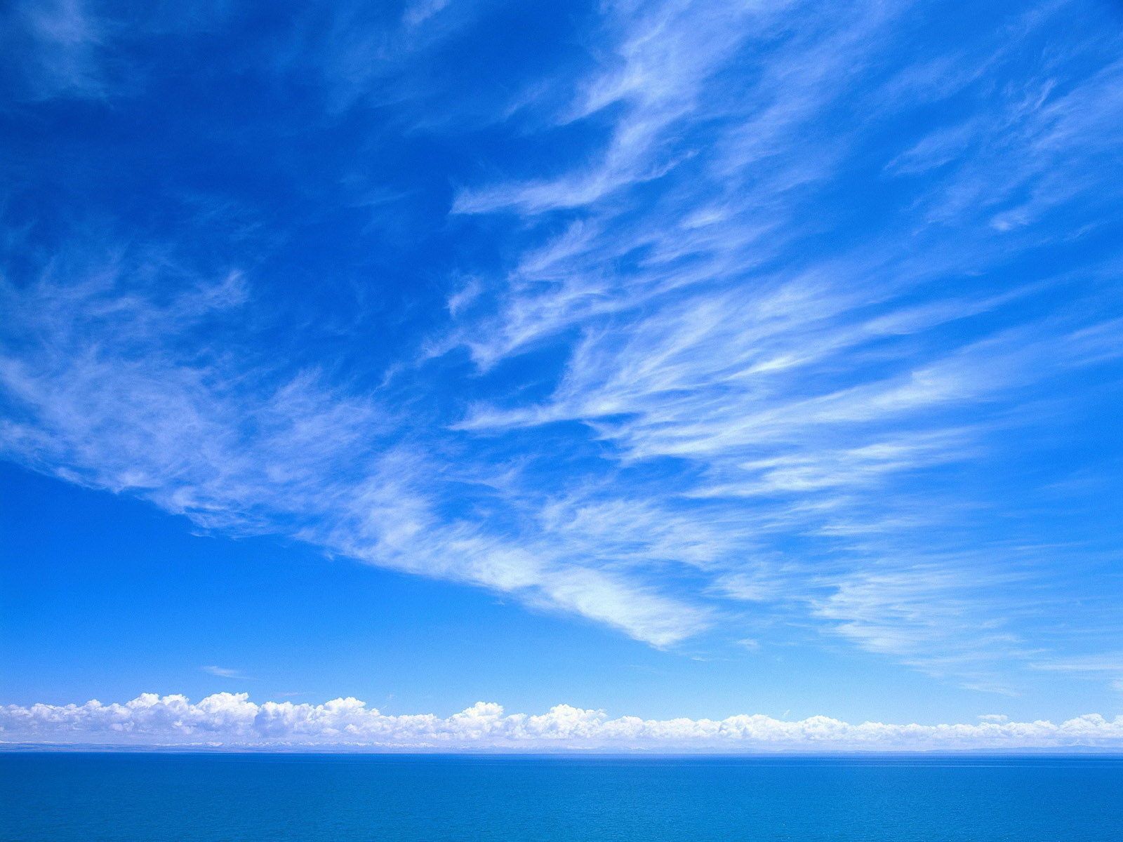 Clear blue sky, dotted with a single fluffy white cloud