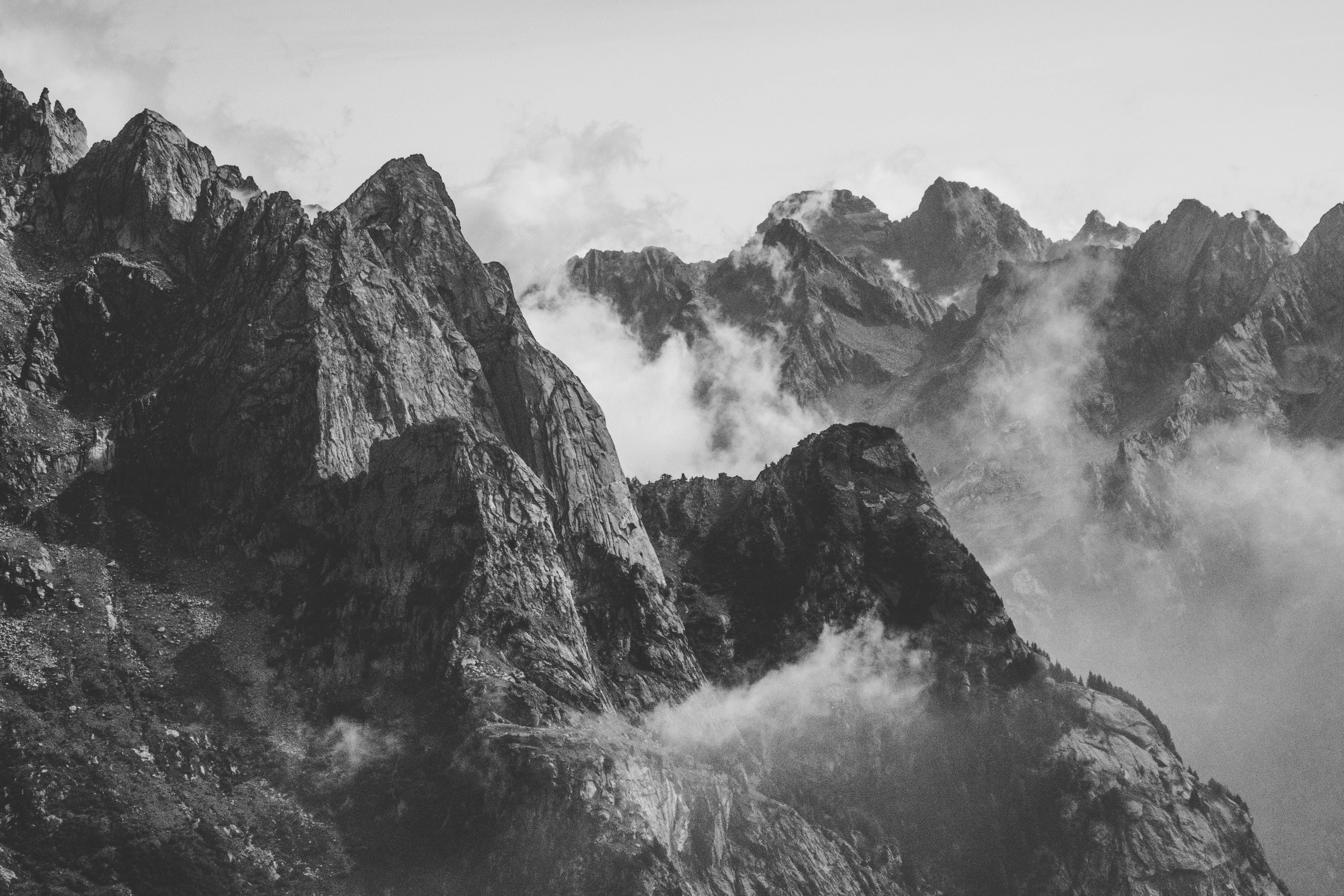 grayscale photography of mountain with smoke photo