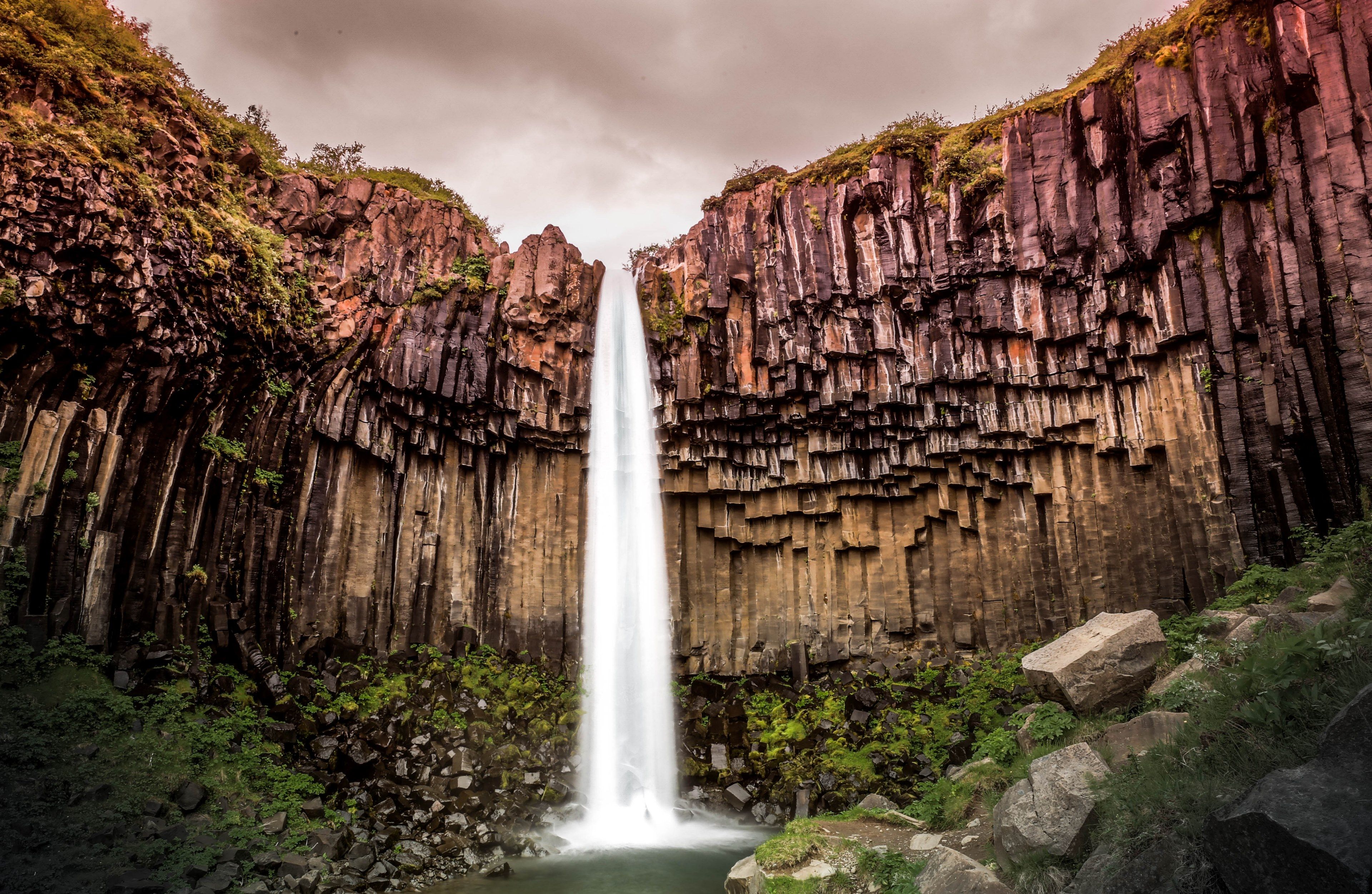 majestic waterfall cascades down a rocky mountainside