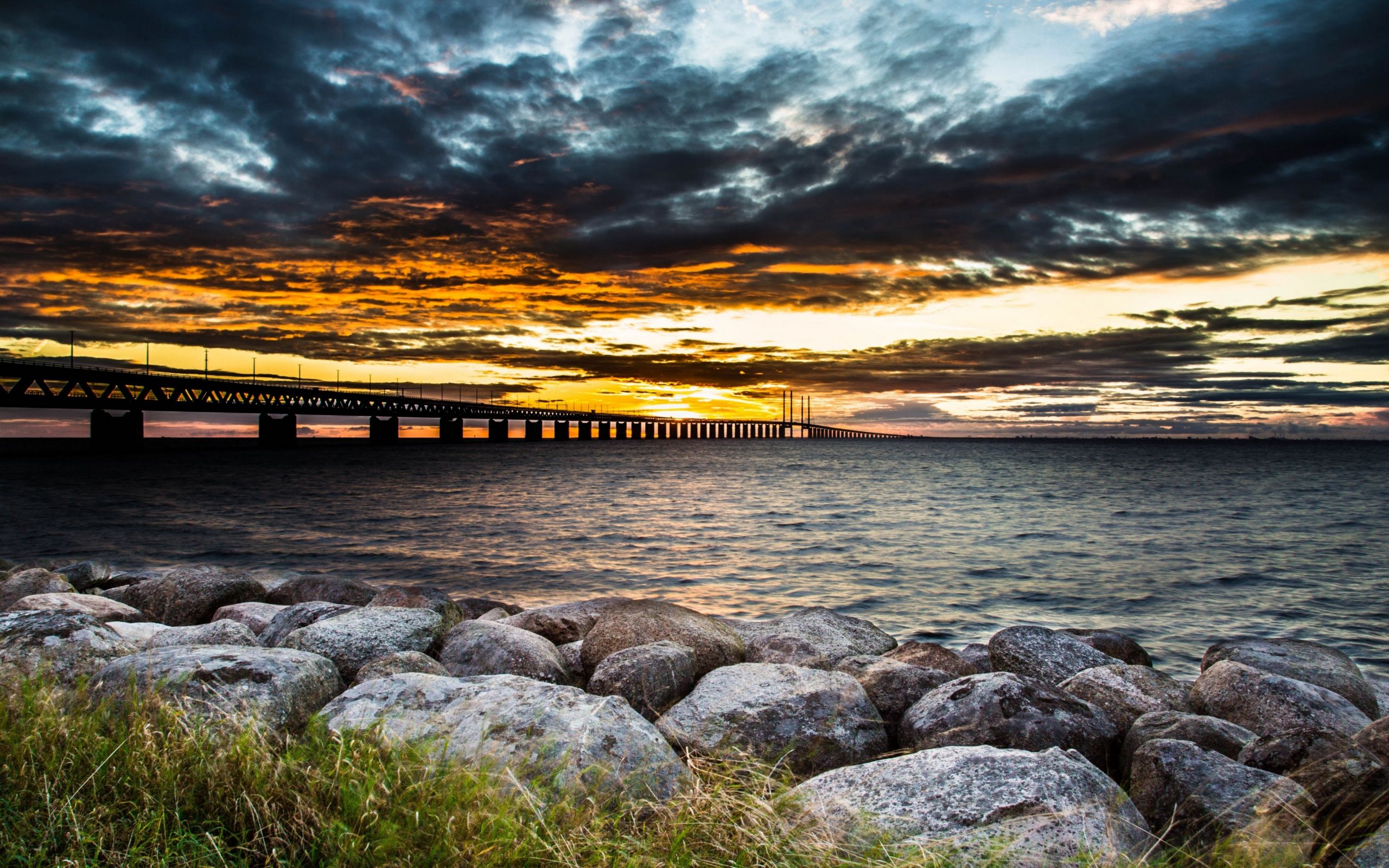 Download 2560x1600 Wallpaper Bridge, Sunset, Clouds, Coast, Rocks
