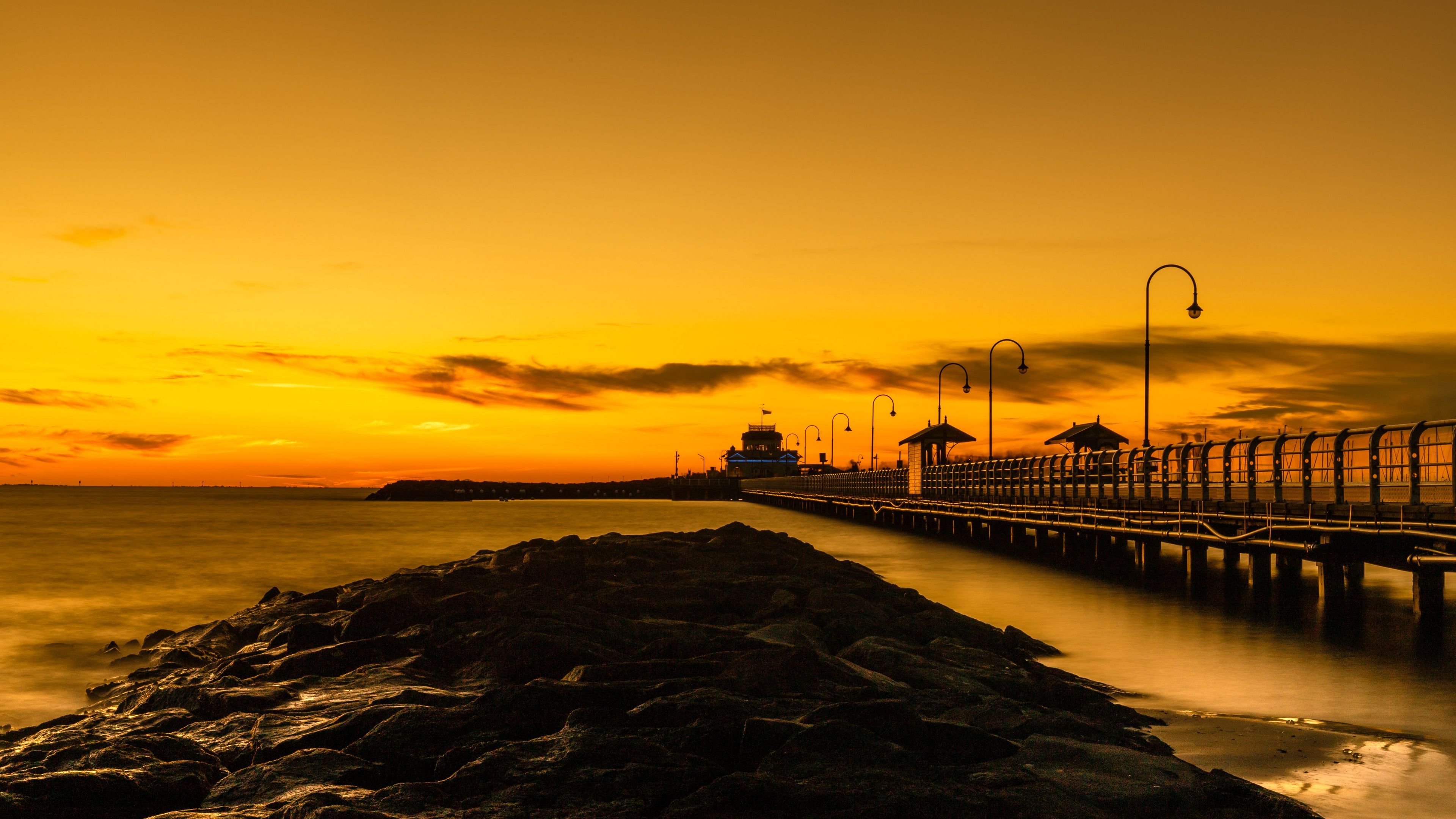 Download wallpaper 3840x2160 bridge, lights, rocks, sunset 4k uhd