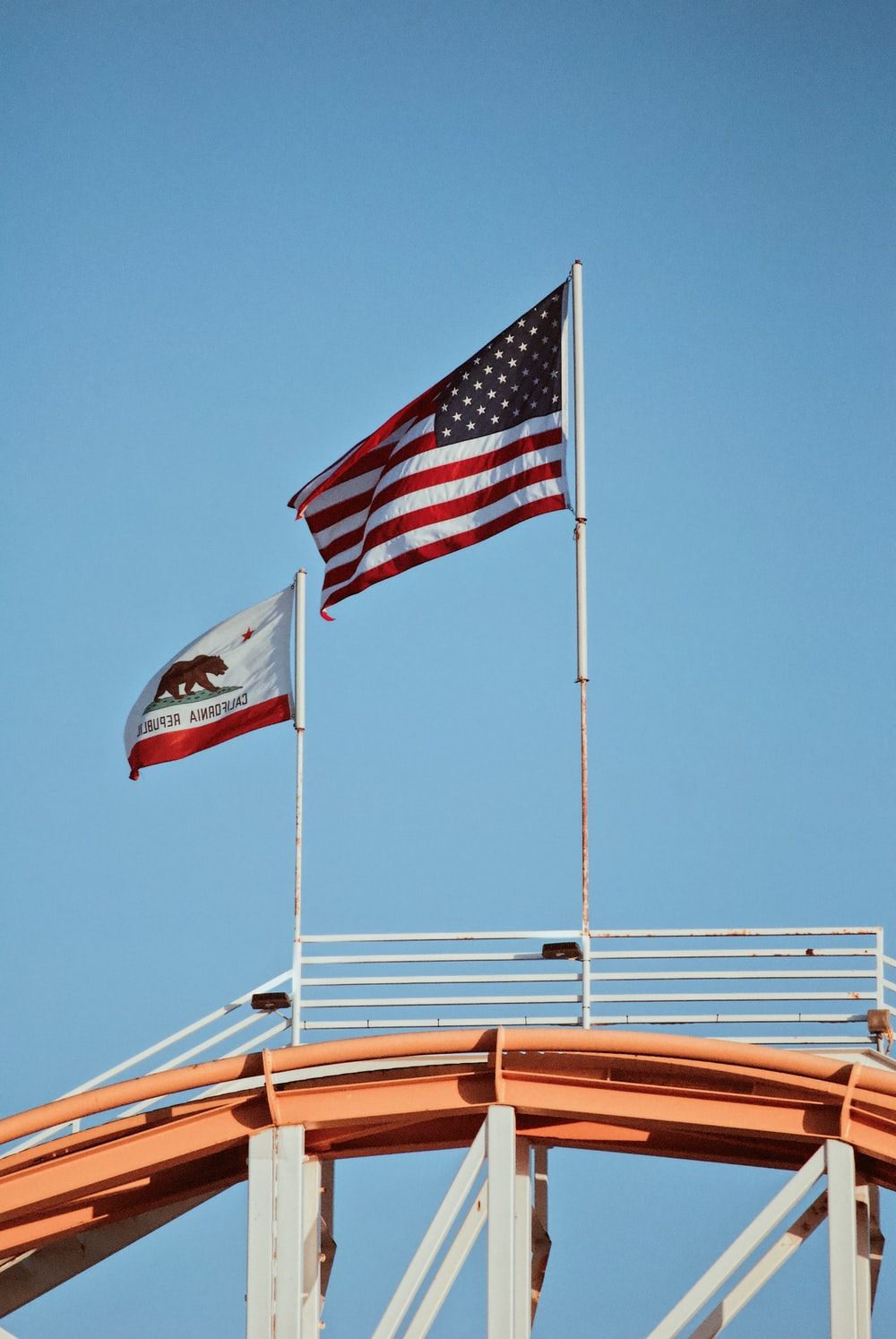 US flag and California flag on poles photo