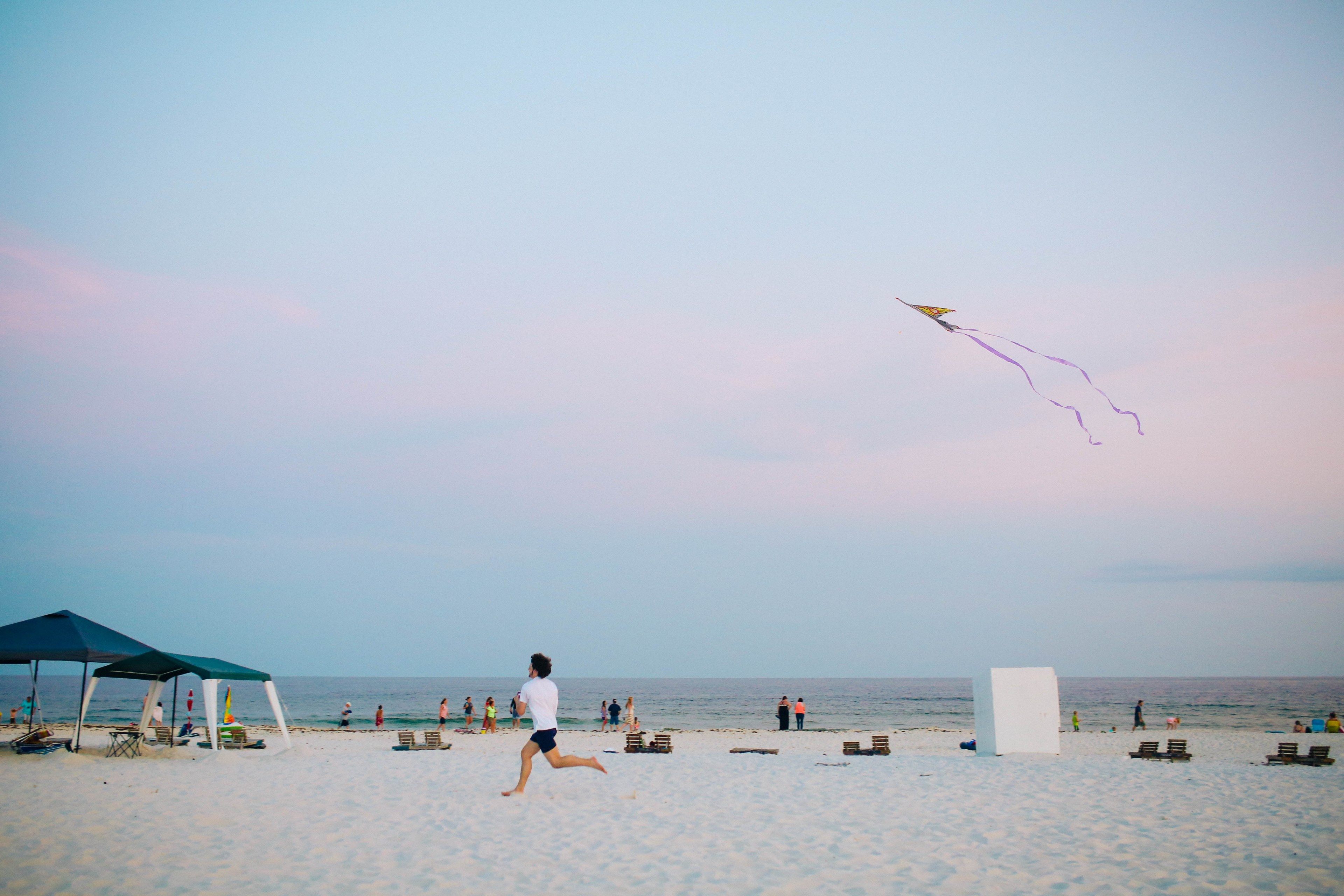 happy summer seaside activity and flying kite at the beachkite
