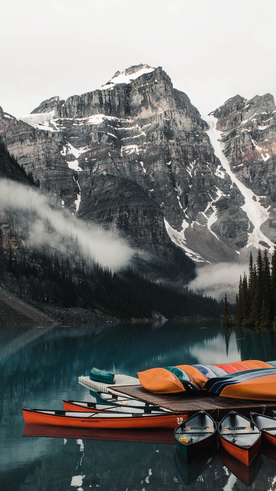 Download wallpaper 938x1668 canoe, boats, lake, pier, mountains