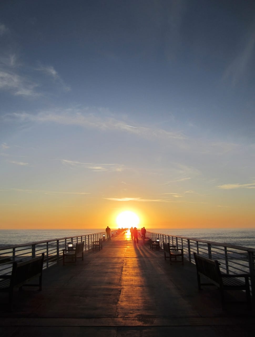 group of people standing on wooden dock during sunset free image
