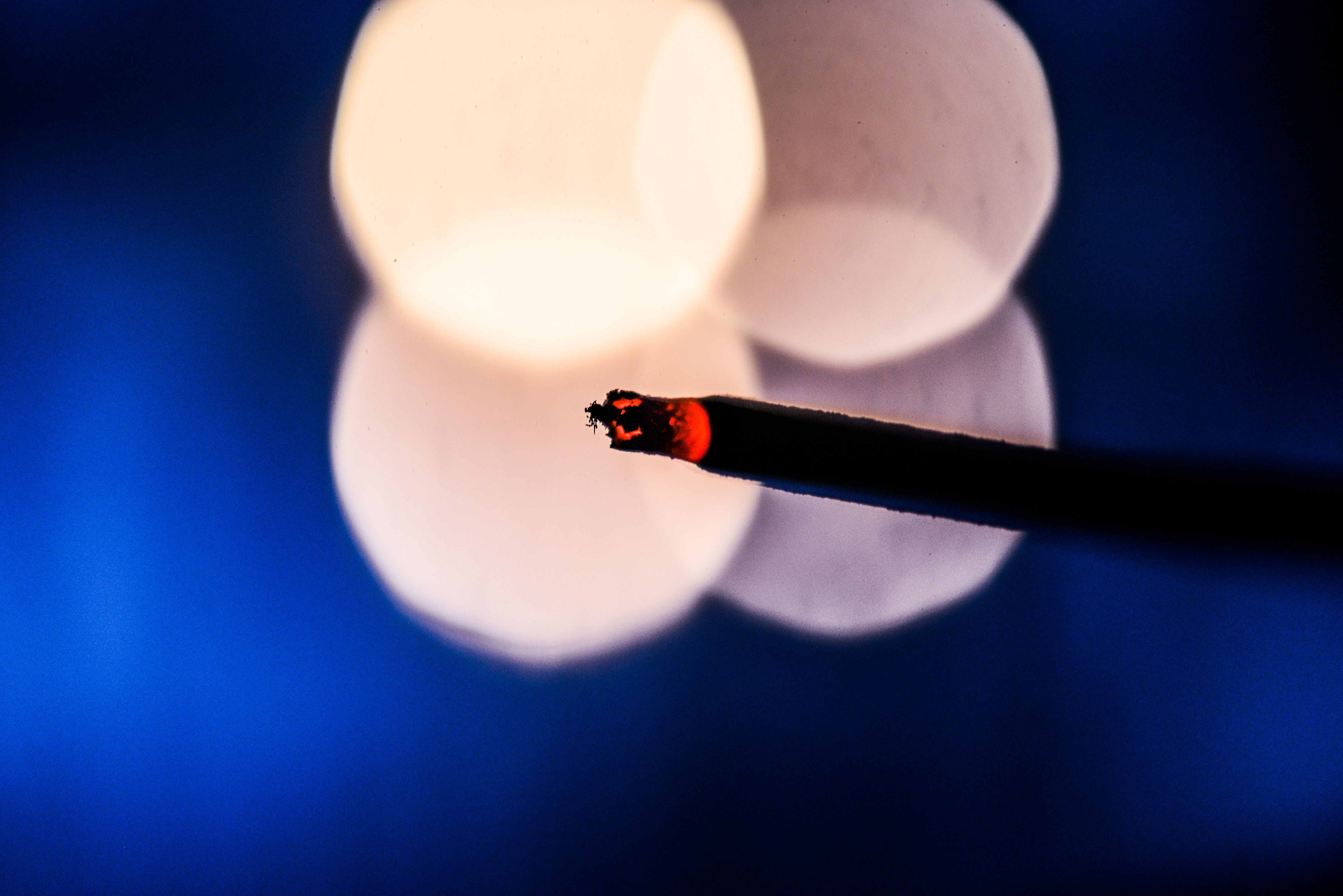 Lighted Cigarette Stick With Bokeh Photography · Free