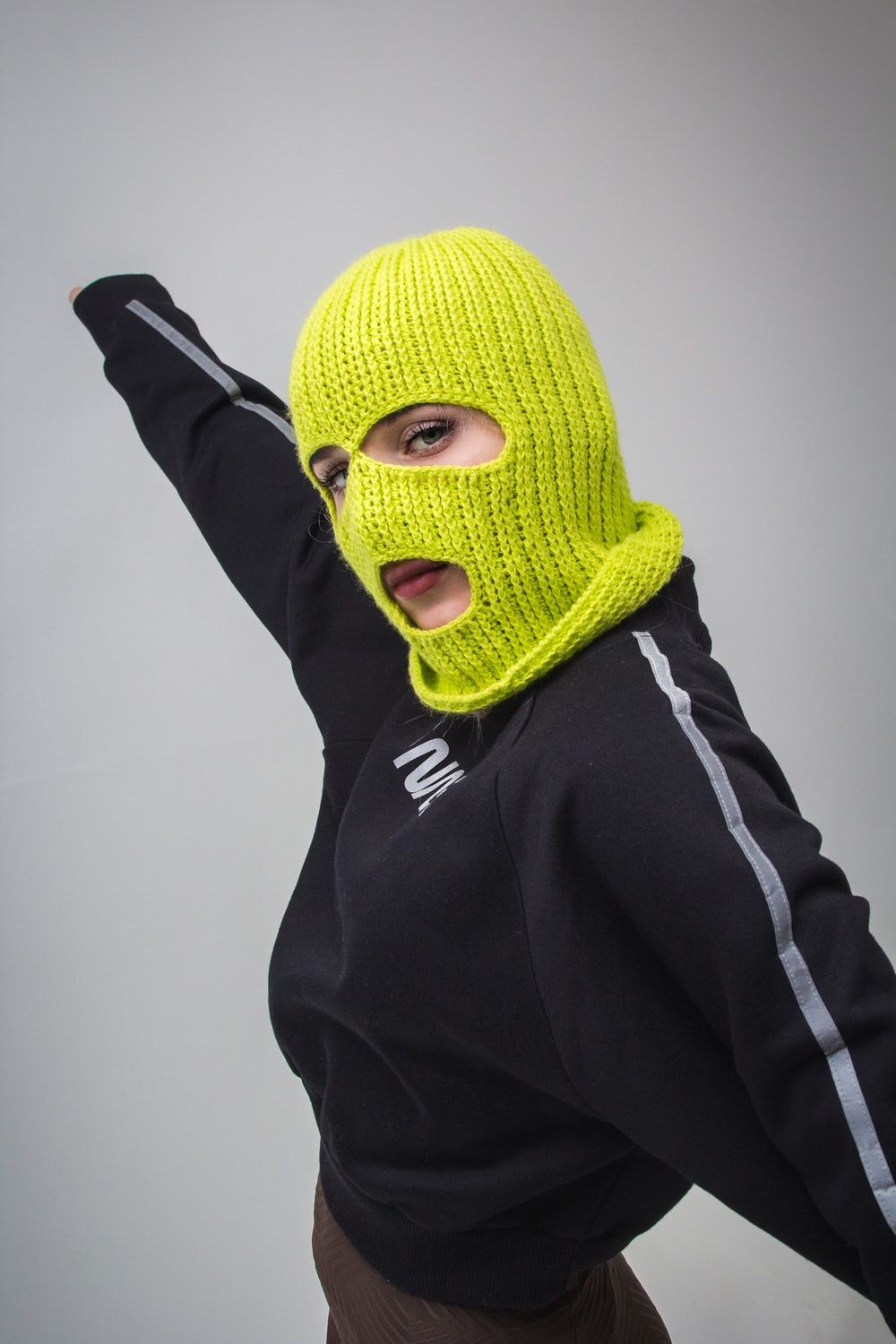 woman in black jacket with yellow ski mask photo