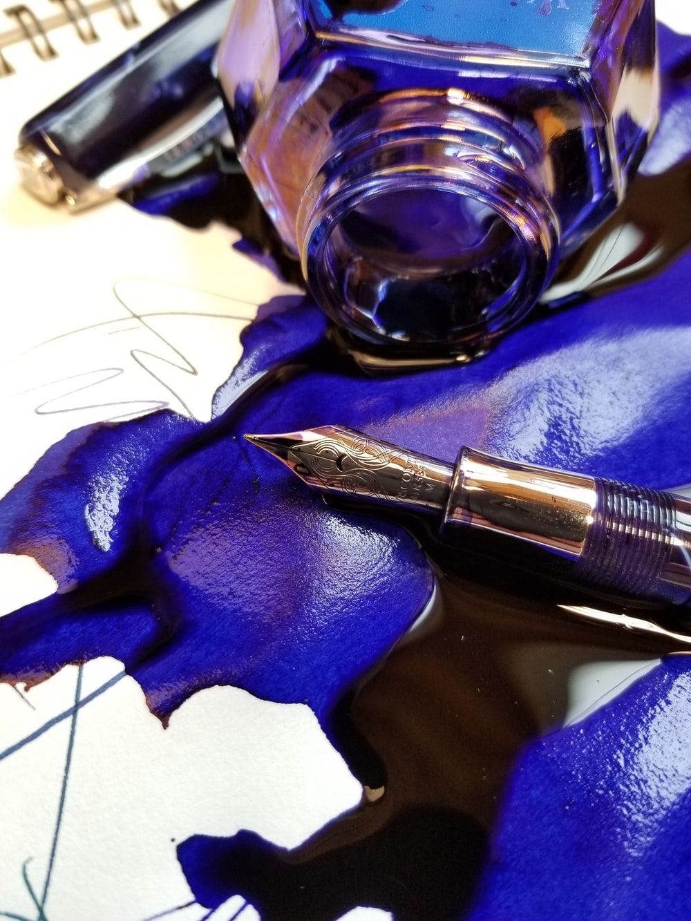 close up photo of spoiled blue ink with fountain pen photo