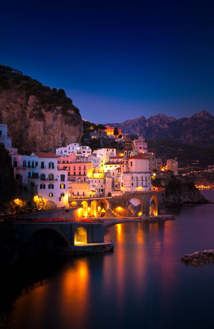 Night view of Amalfi cityscape on coast line of mediterranean sea
