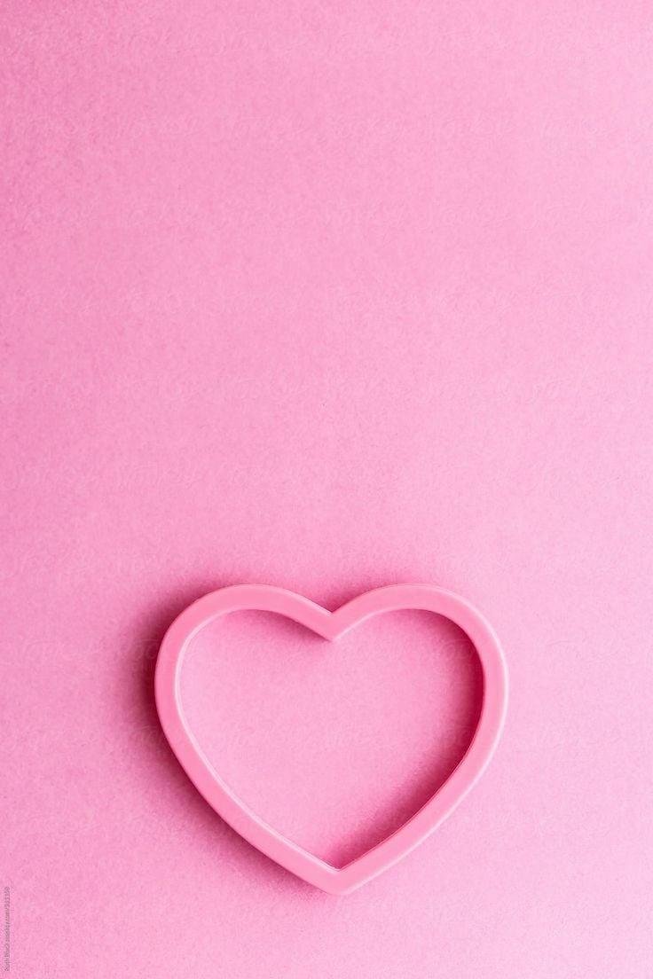 Heart shaped cookie cutter on pink by Ruth Black for Stocksy