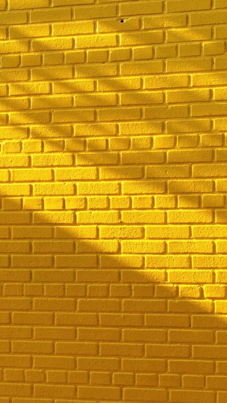 Yellow brick wall with beautiful lighting. Yellow wallpaper, Yellow aesthetic, Aesthetic wallpaper