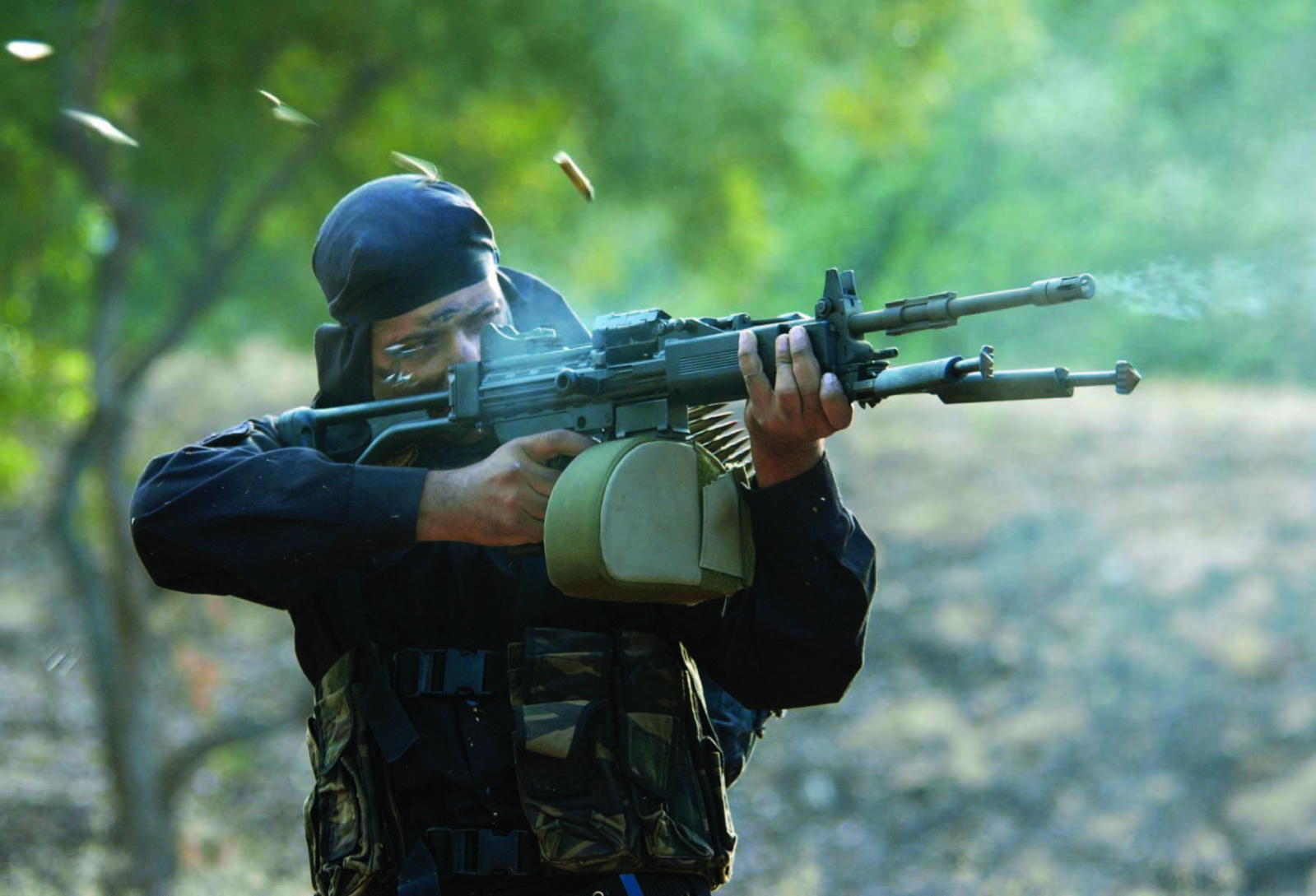 A member of the Indian Special Forces fires his weapon 1599x1089