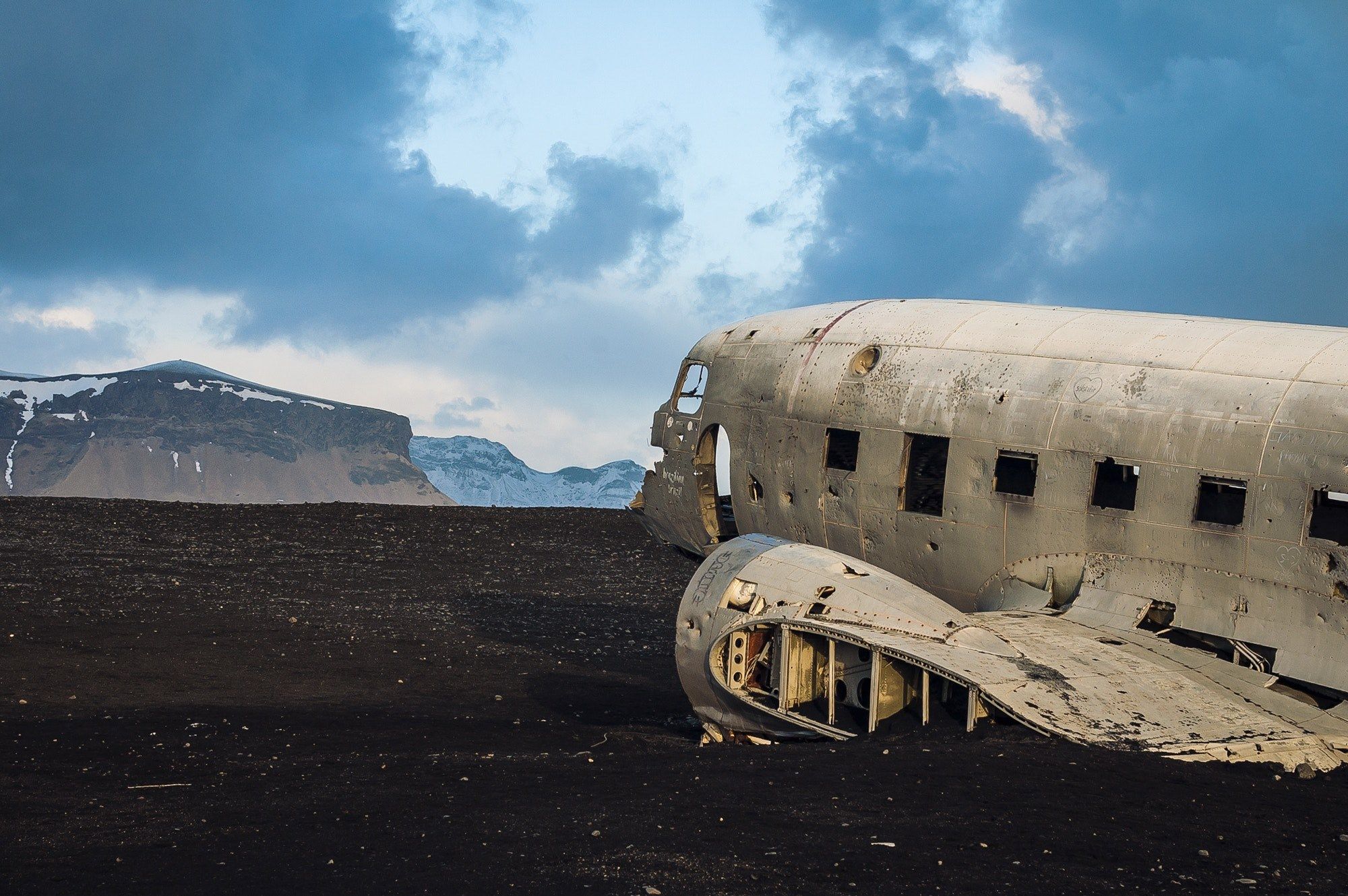 abandoned airplane wreckage by a mountain landscapedesert plane